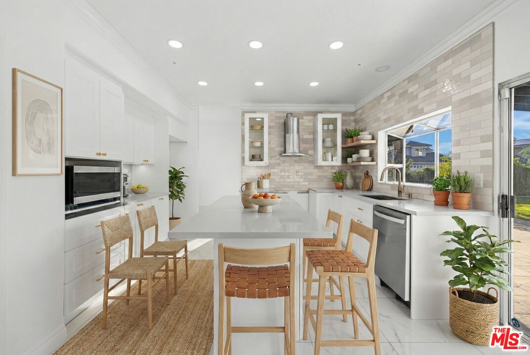 6758 Ridgeline Avenue San Bernardino, CA 92407 - Photo 18 of 67 a view of a dining room with furniture a kitchen and chandelier