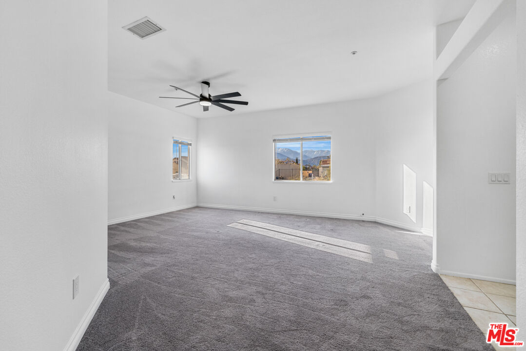 6758 Ridgeline Avenue San Bernardino, CA 92407 - Photo 21 of 67 an empty room with a ceiling fan and window