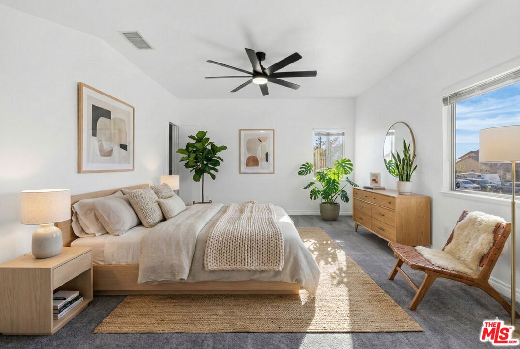 6758 Ridgeline Avenue San Bernardino, CA 92407 - Photo 22 of 67 a living room with a bed furniture and a potted plant