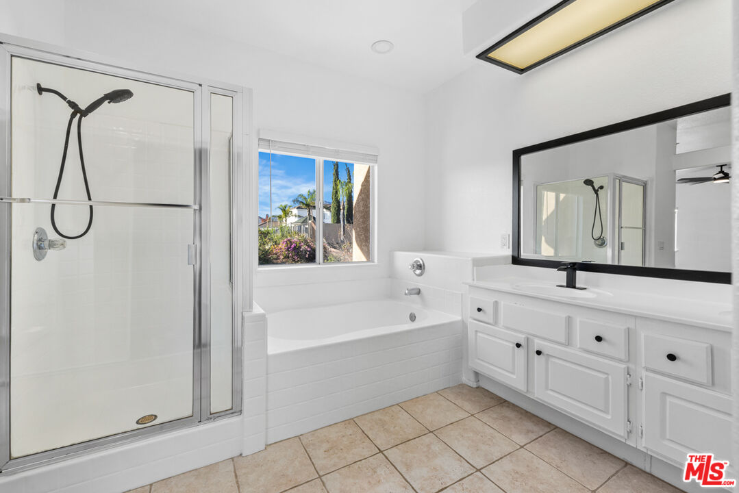 6758 Ridgeline Avenue San Bernardino, CA 92407 - Photo 30 of 67 a bathroom with a tub sink shower and mirror