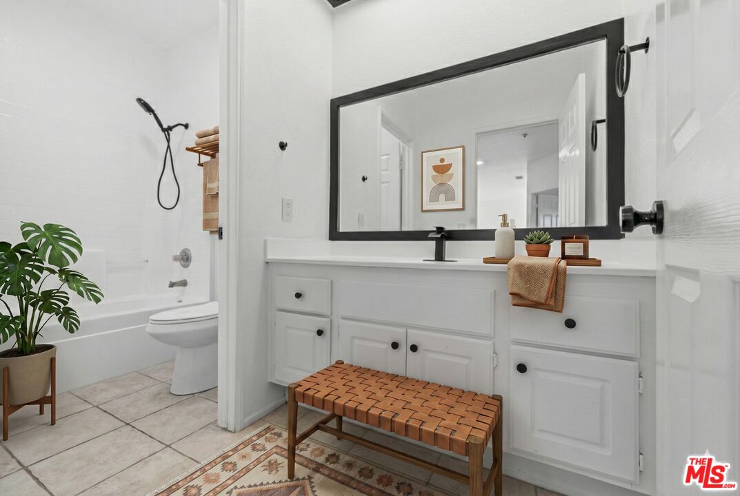 6758 Ridgeline Avenue San Bernardino, CA 92407 - Photo 34 of 67 a bathroom with a sink a toilet and a mirror