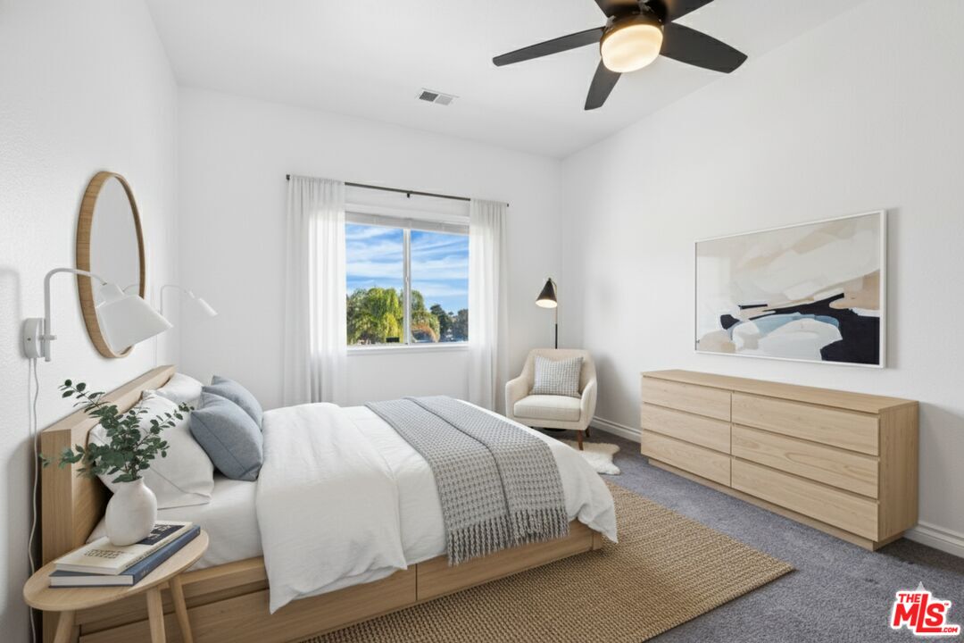 6758 Ridgeline Avenue San Bernardino, CA 92407 - Photo 39 of 67 a bedroom with a bed and a chandelier