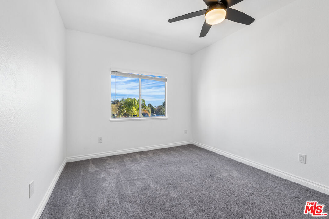 6758 Ridgeline Avenue San Bernardino, CA 92407 - Photo 40 of 67 an empty room with a window and a ceiling fan