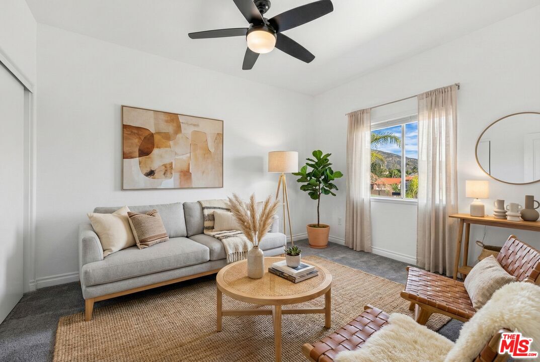 6758 Ridgeline Avenue San Bernardino, CA 92407 - Photo 41 of 67 a living room with furniture and a wooden floor