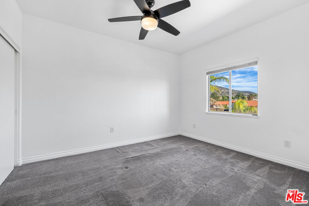 6758 Ridgeline Avenue San Bernardino, CA 92407 - Photo 42 of 67 an empty room with a window and a ceiling fan