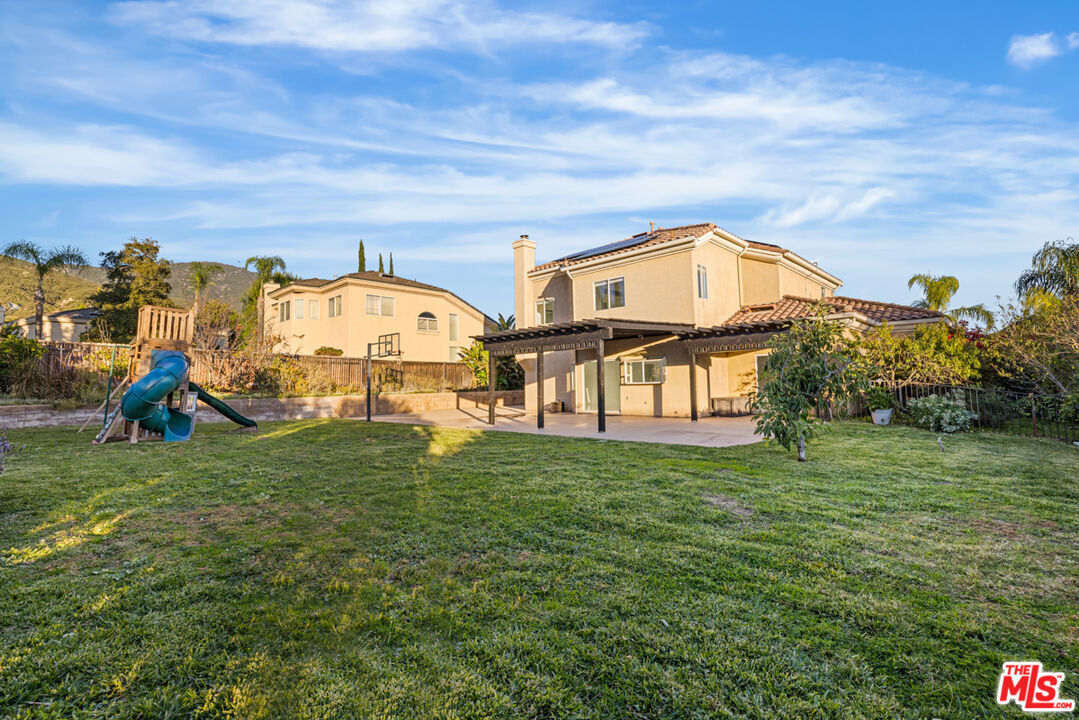 6758 Ridgeline Avenue San Bernardino, CA 92407 - Photo 46 of 67 a view of a big house with a big yard and large trees