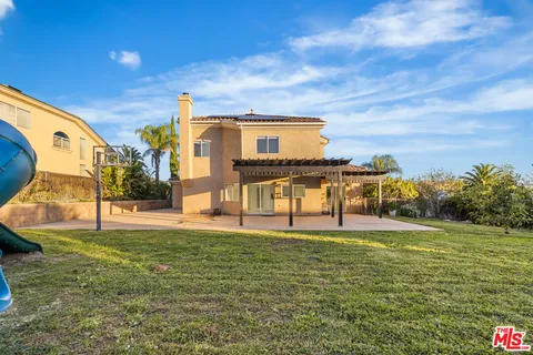 a front view of a house with a palm tree