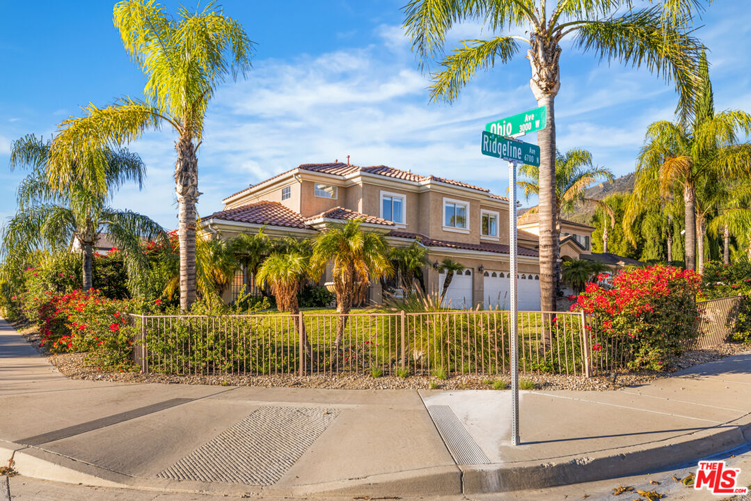 6758 Ridgeline Avenue San Bernardino, CA 92407 - Photo 63 of 67 a front view of a house with a palm tree