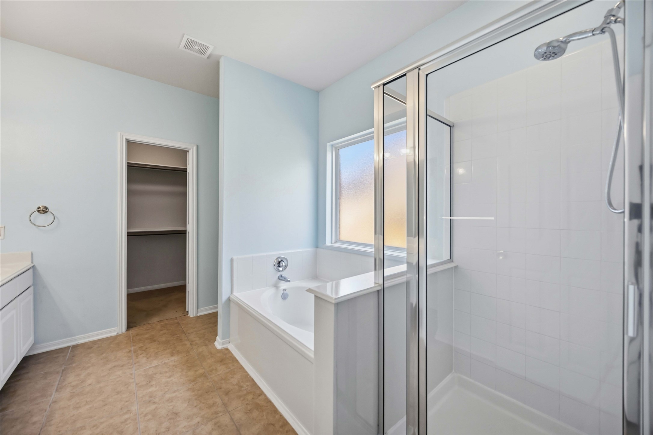 29526 Winton Wood Way Spring, TX 77386 - Photo 12 of 29 First-floor primary en suite featuring large vanity, a soaking tub, separate shower, and a spacious walk-in closet.