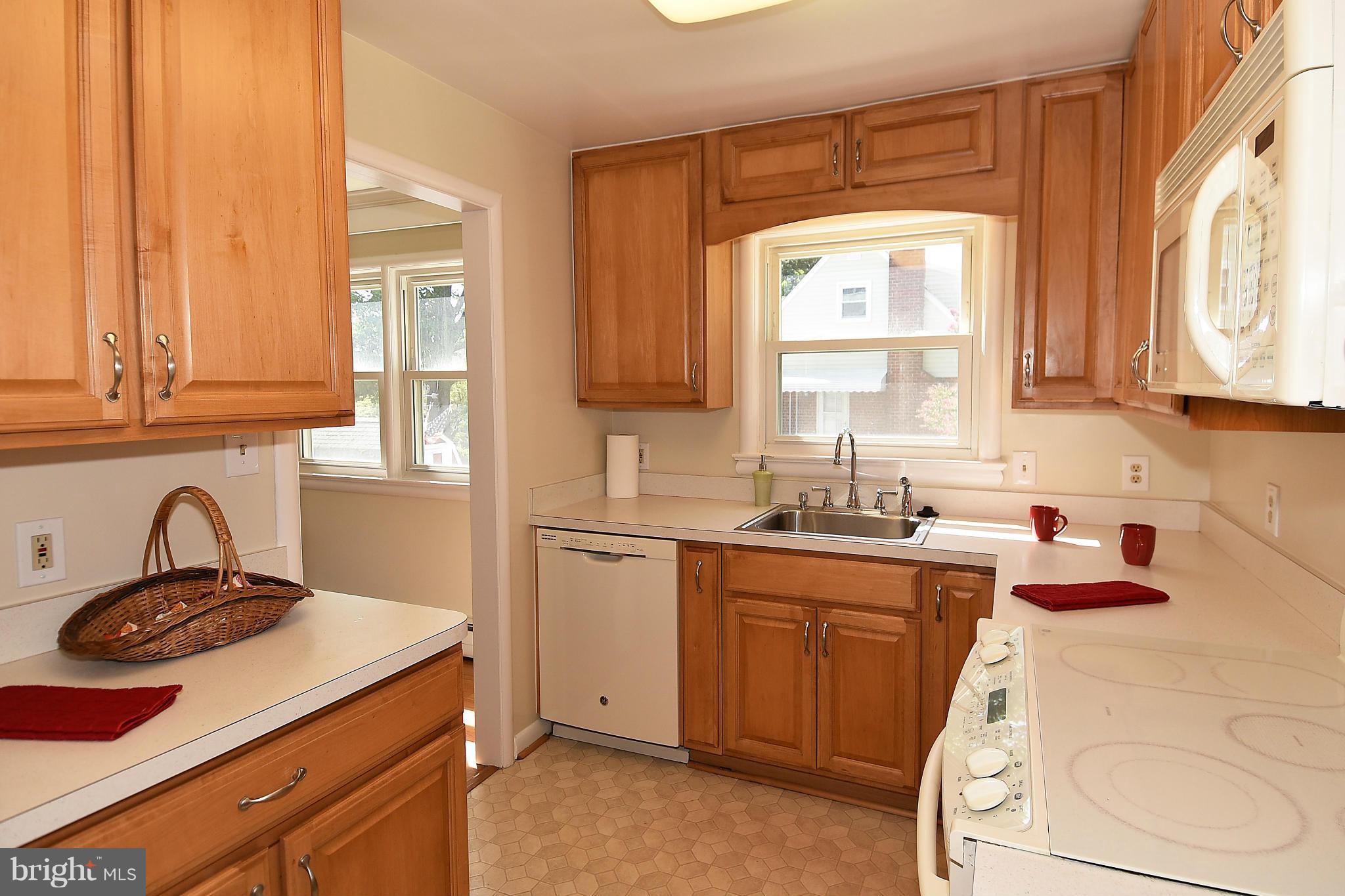 3206 Weller Road Silver Spring, MD 20906 - Photo 11 of 30 a kitchen with a sink stove and cabinets