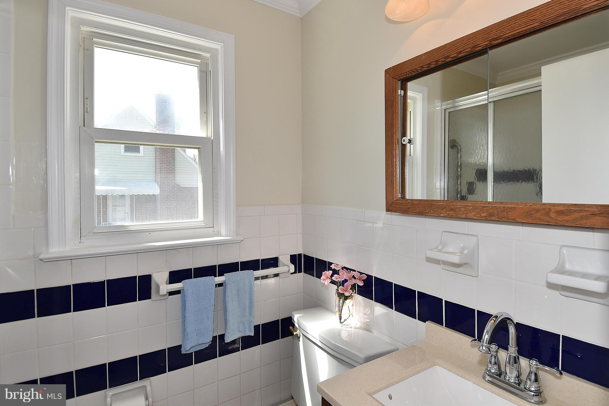 3206 Weller Road Silver Spring, MD 20906 - Photo 15 of 30 a bathroom with a sink a mirror and a window