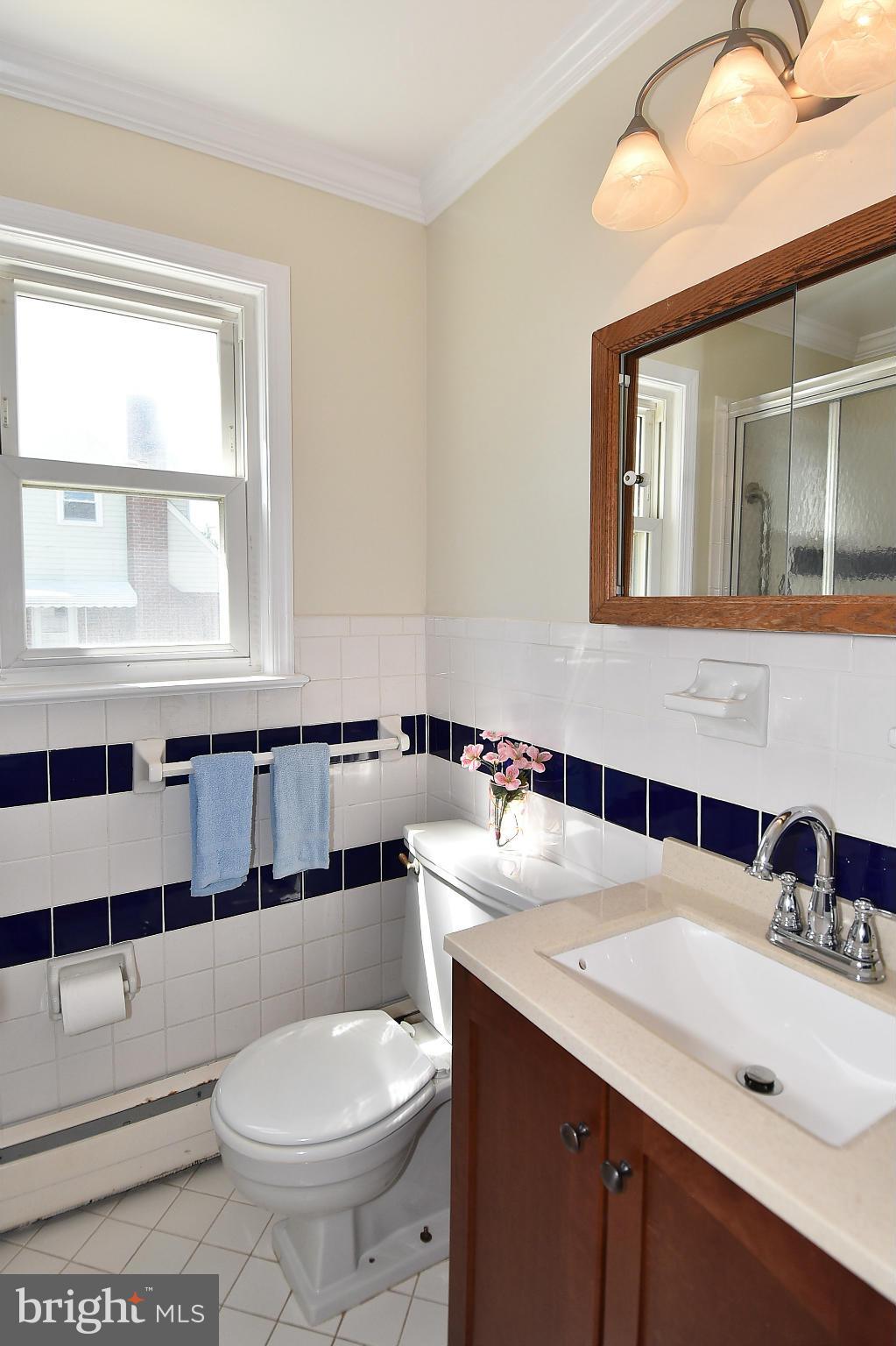 3206 Weller Road Silver Spring, MD 20906 - Photo 16 of 30 a bathroom with a toilet a sink and mirror