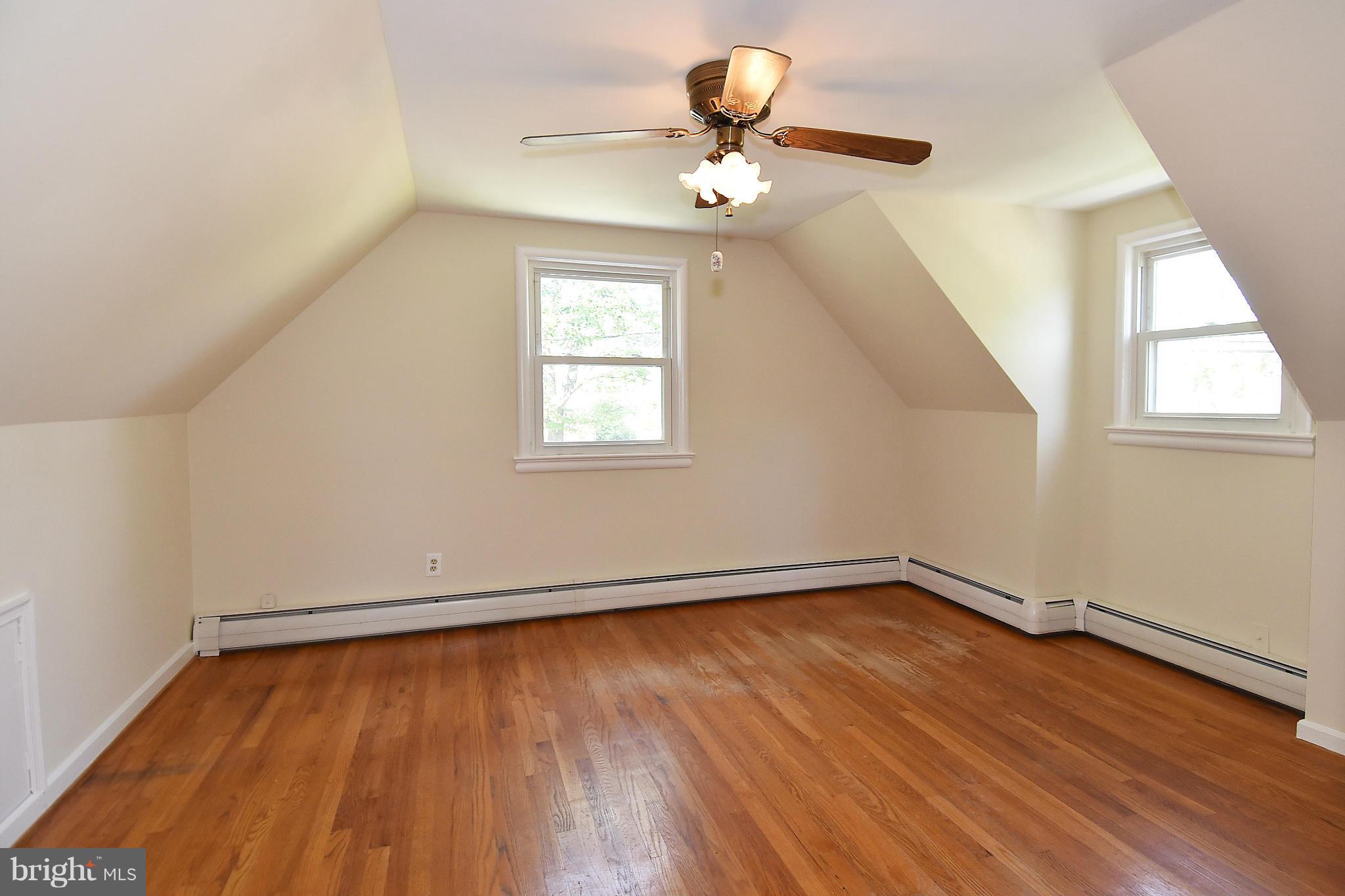 3206 Weller Road Silver Spring, MD 20906 - Photo 19 of 30 an empty room with wooden floor fan and windows