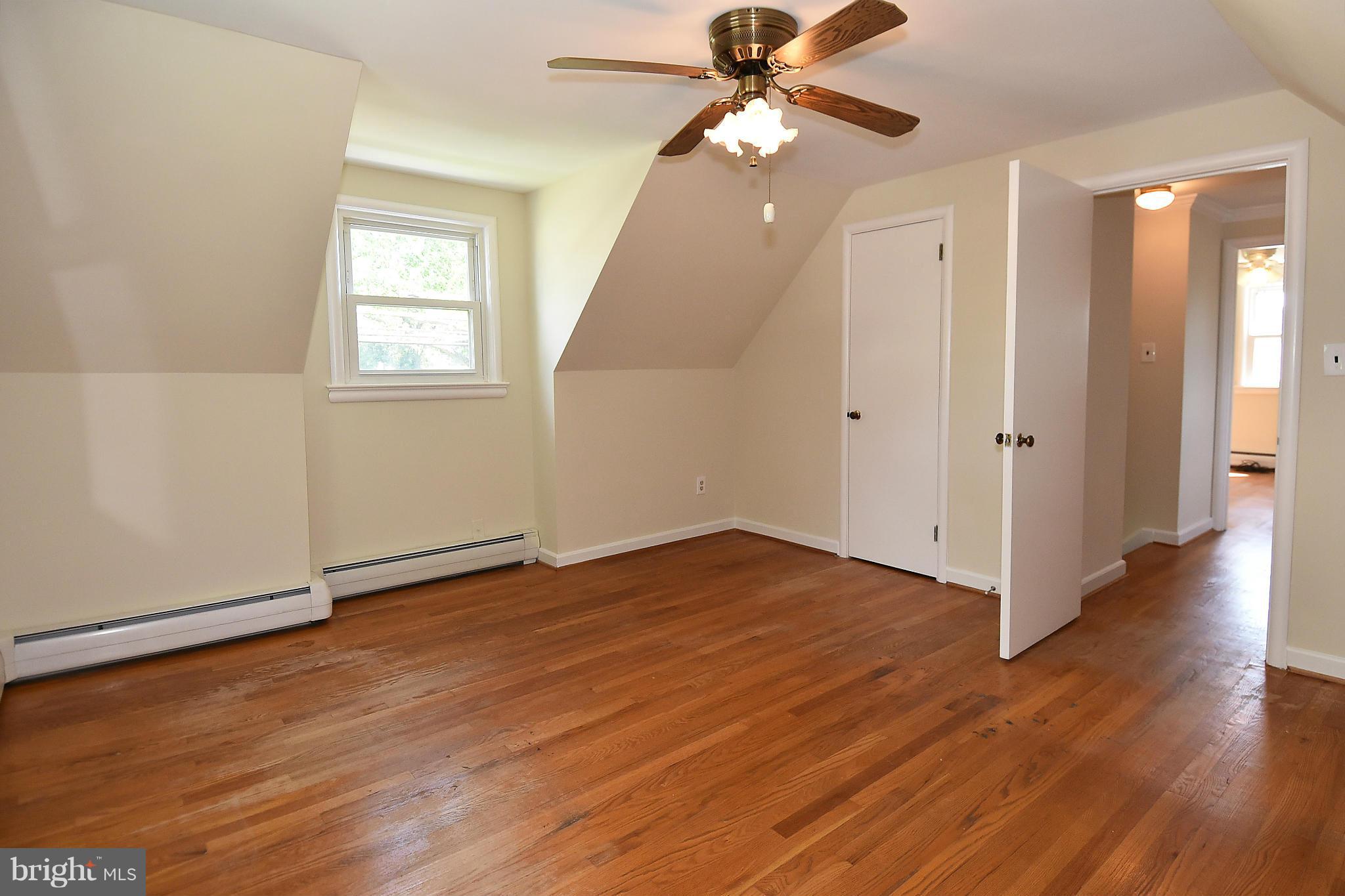 3206 Weller Road Silver Spring, MD 20906 - Photo 20 of 30 an empty room with wooden floor fan and windows