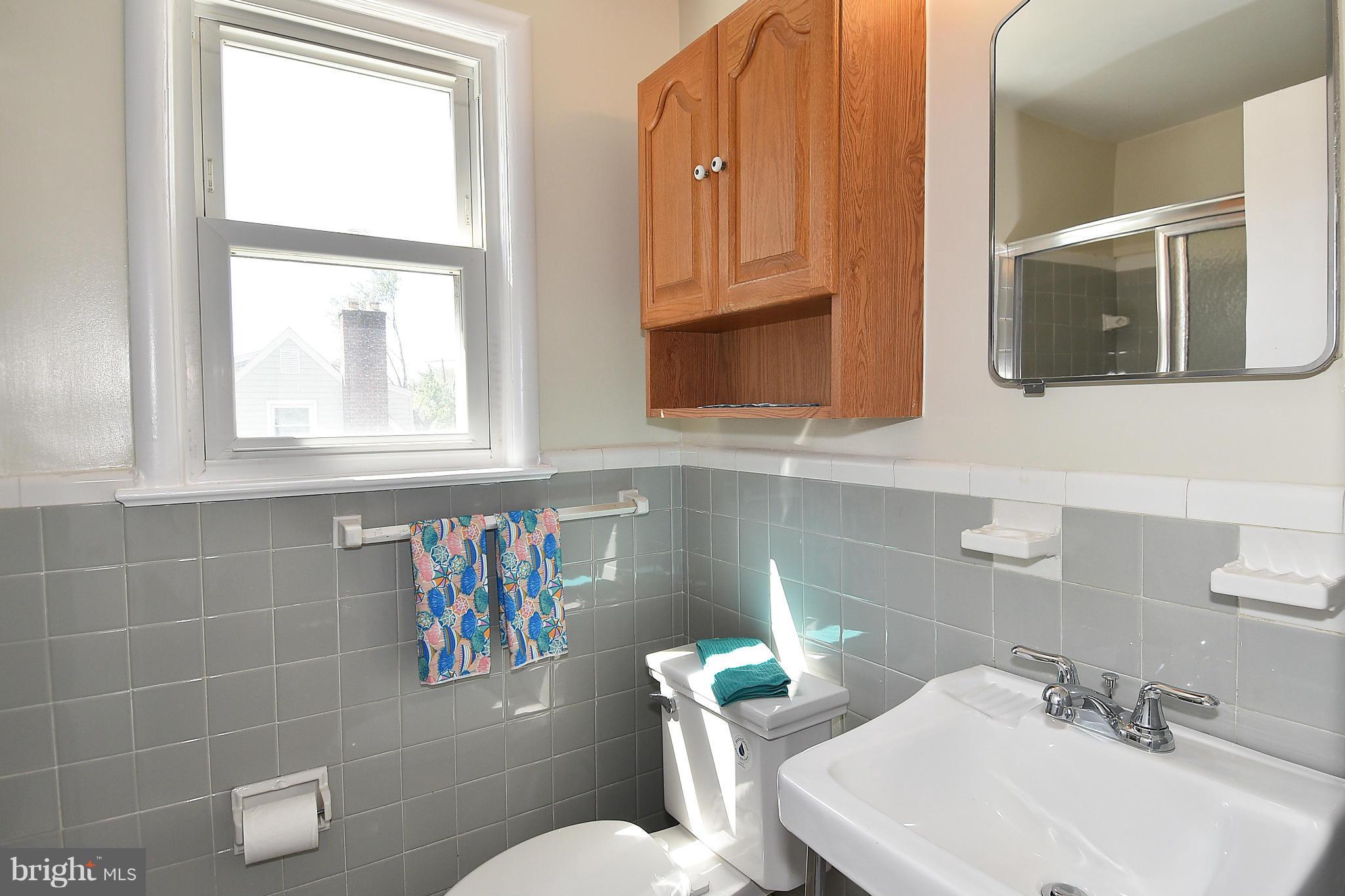 3206 Weller Road Silver Spring, MD 20906 - Photo 21 of 30 a bathroom with a sink a toilet and a mirror