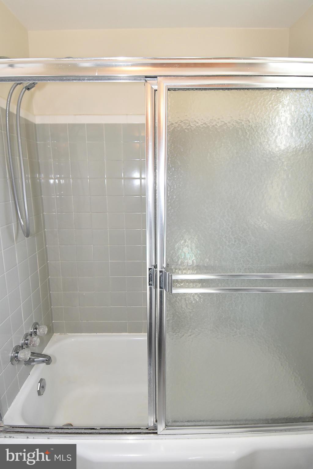 3206 Weller Road Silver Spring, MD 20906 - Photo 22 of 30 a bathroom with a shower and a glass door