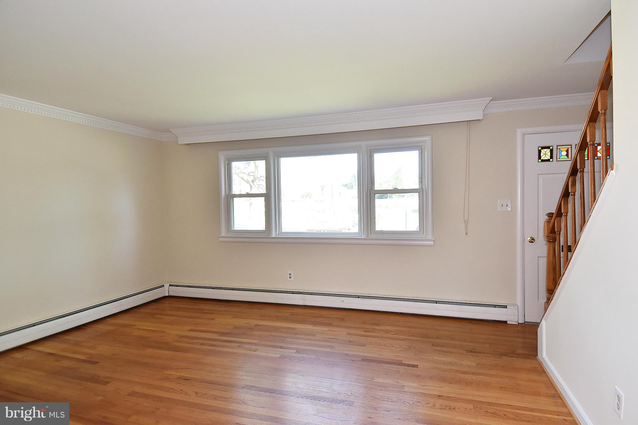 3206 Weller Road Silver Spring, MD 20906 - Photo 4 of 30 a view of an empty room with wooden floor and a window