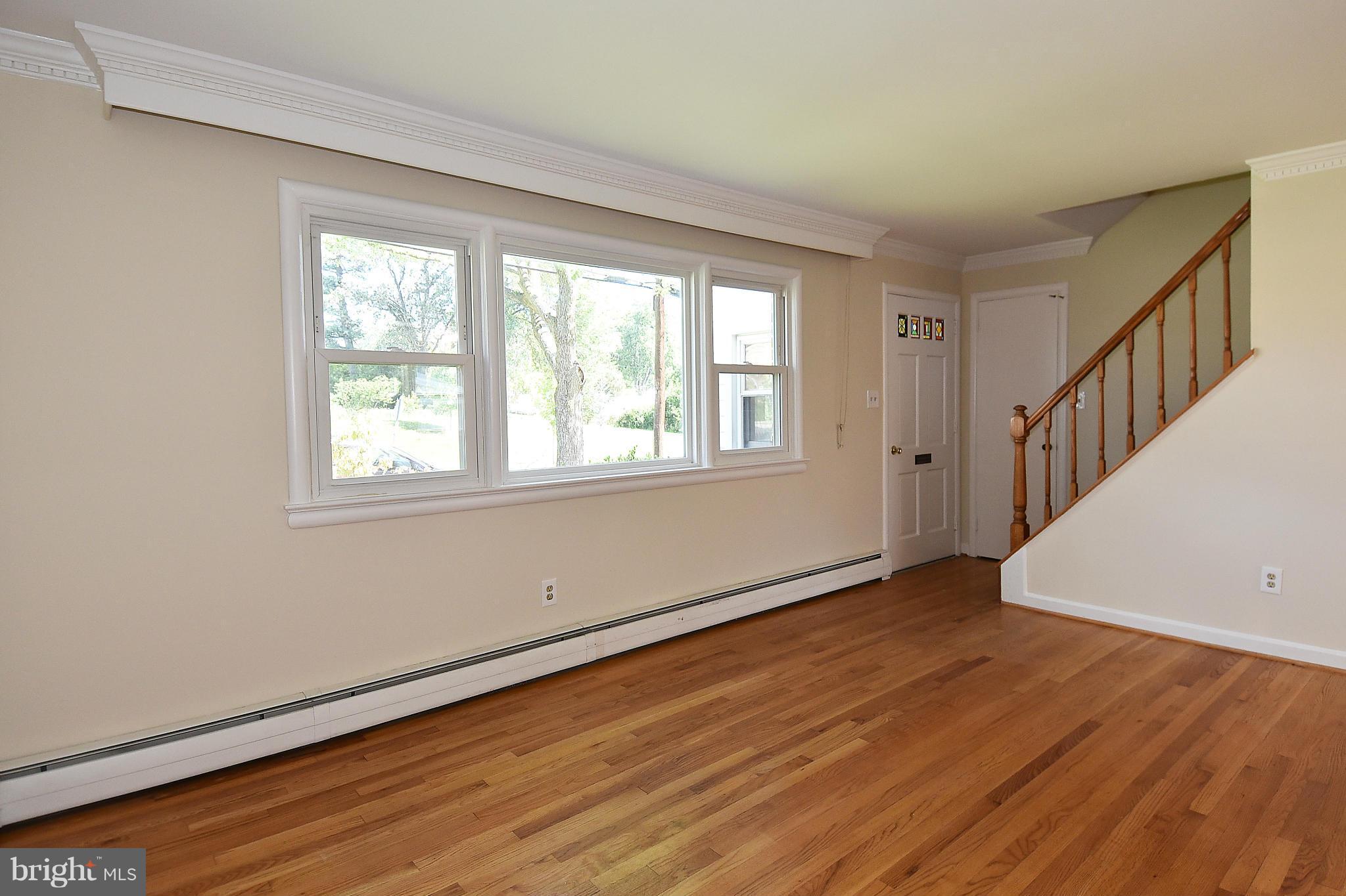 3206 Weller Road Silver Spring, MD 20906 - Photo 6 of 30 a view of an empty room with wooden floor and a window