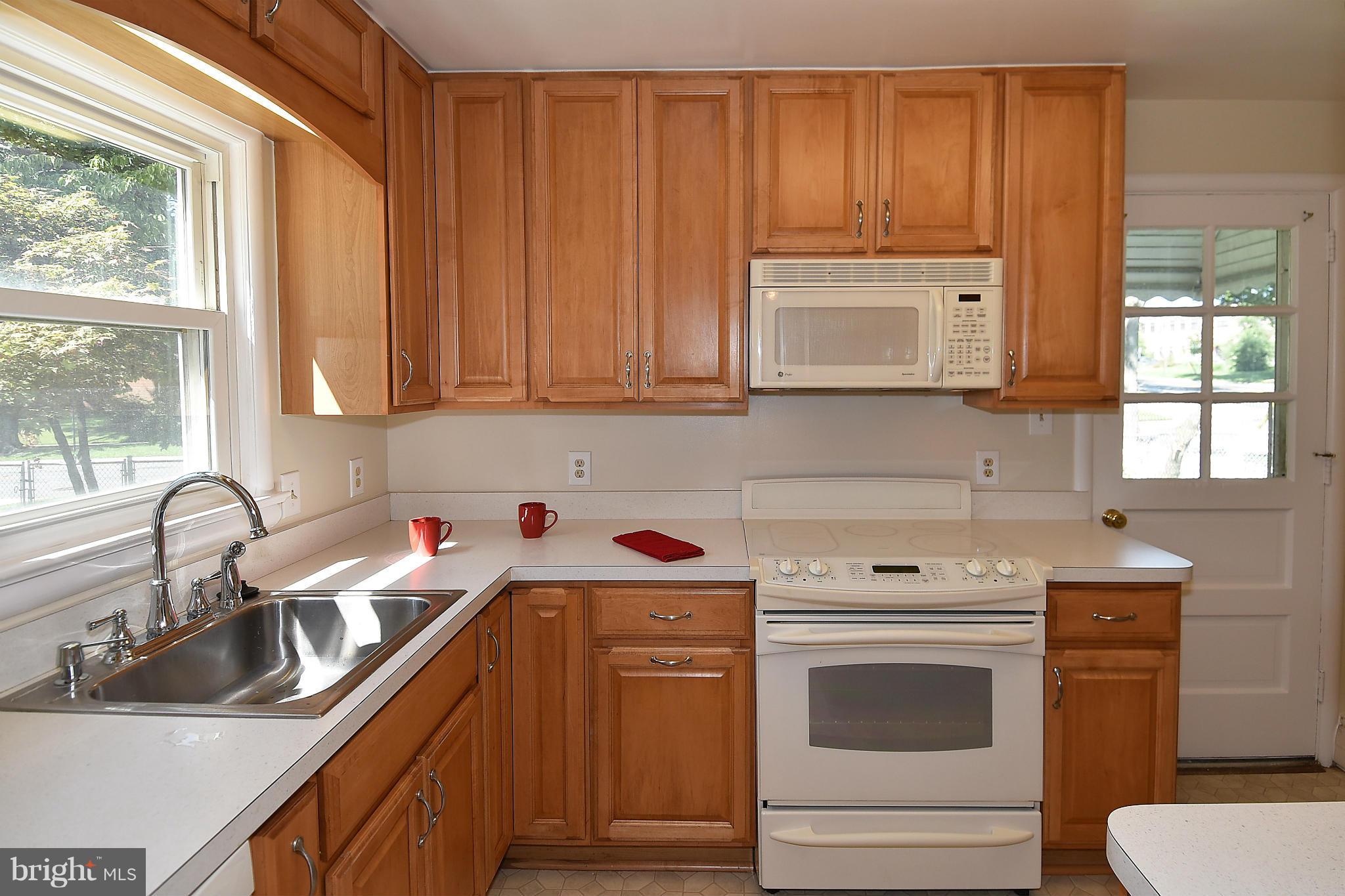 3206 Weller Road Silver Spring, MD 20906 - Photo 9 of 30 a kitchen with a sink cabinets and window