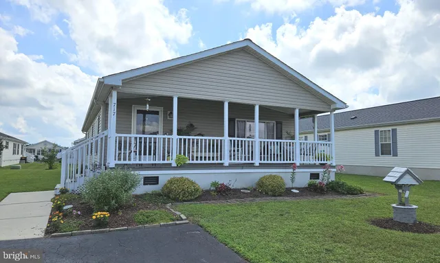 a view of a house with a yard and sitting area