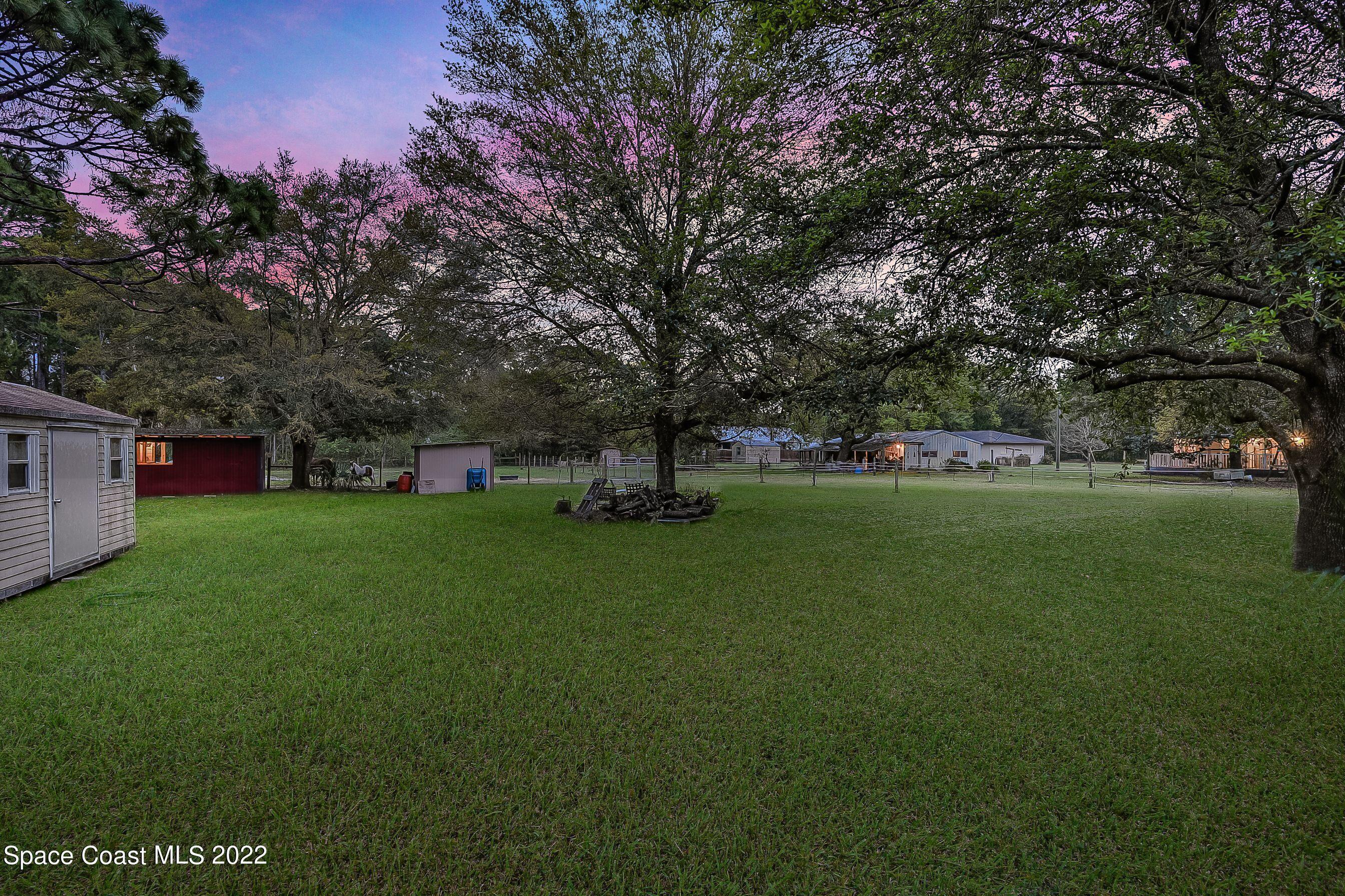 4124 April Lane Mims, FL 32754 - Photo 12 of 44 a green field with lots of trees in it