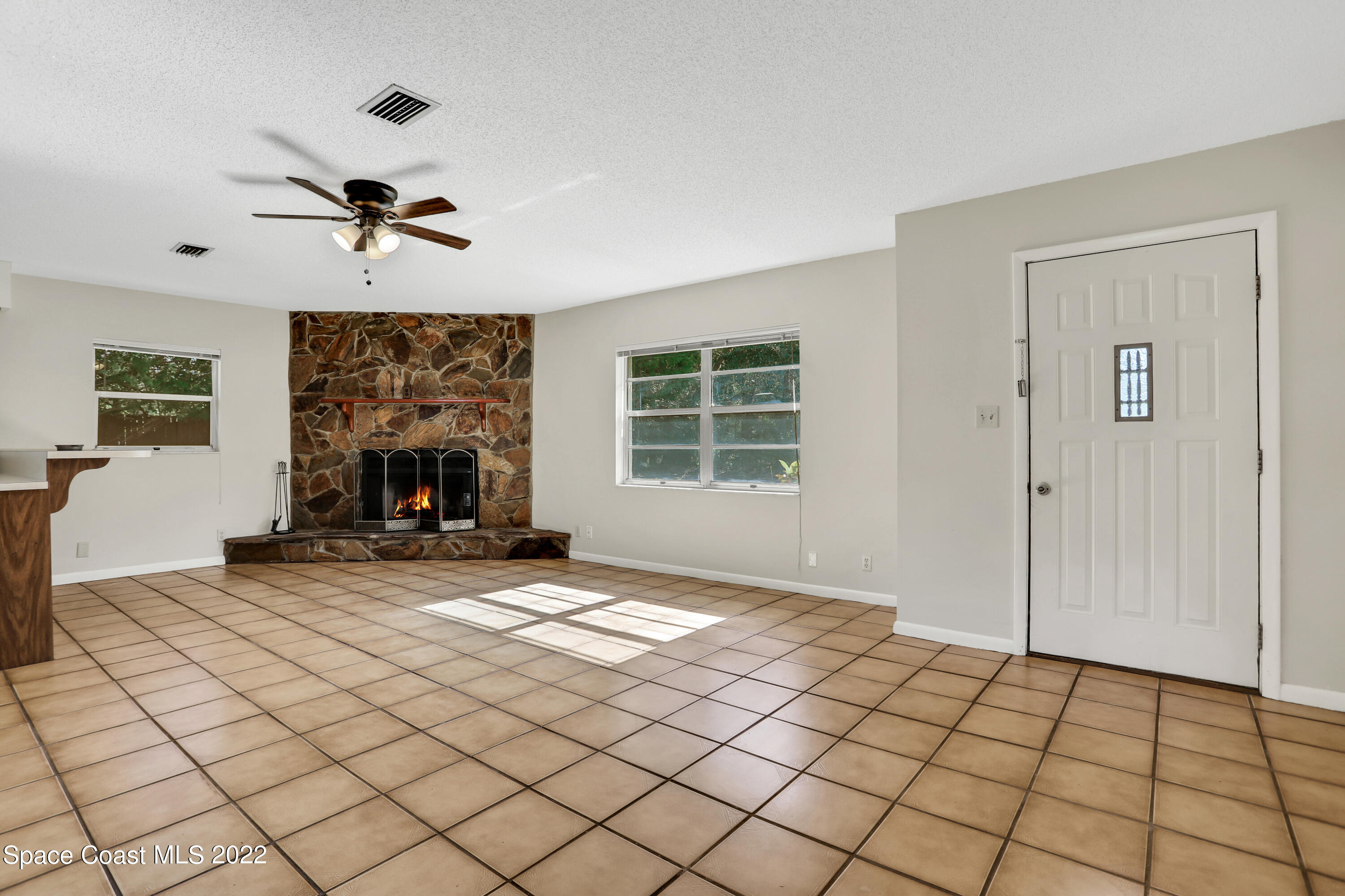 4124 April Lane Mims, FL 32754 - Photo 14 of 44 a view of an empty room with a fireplace