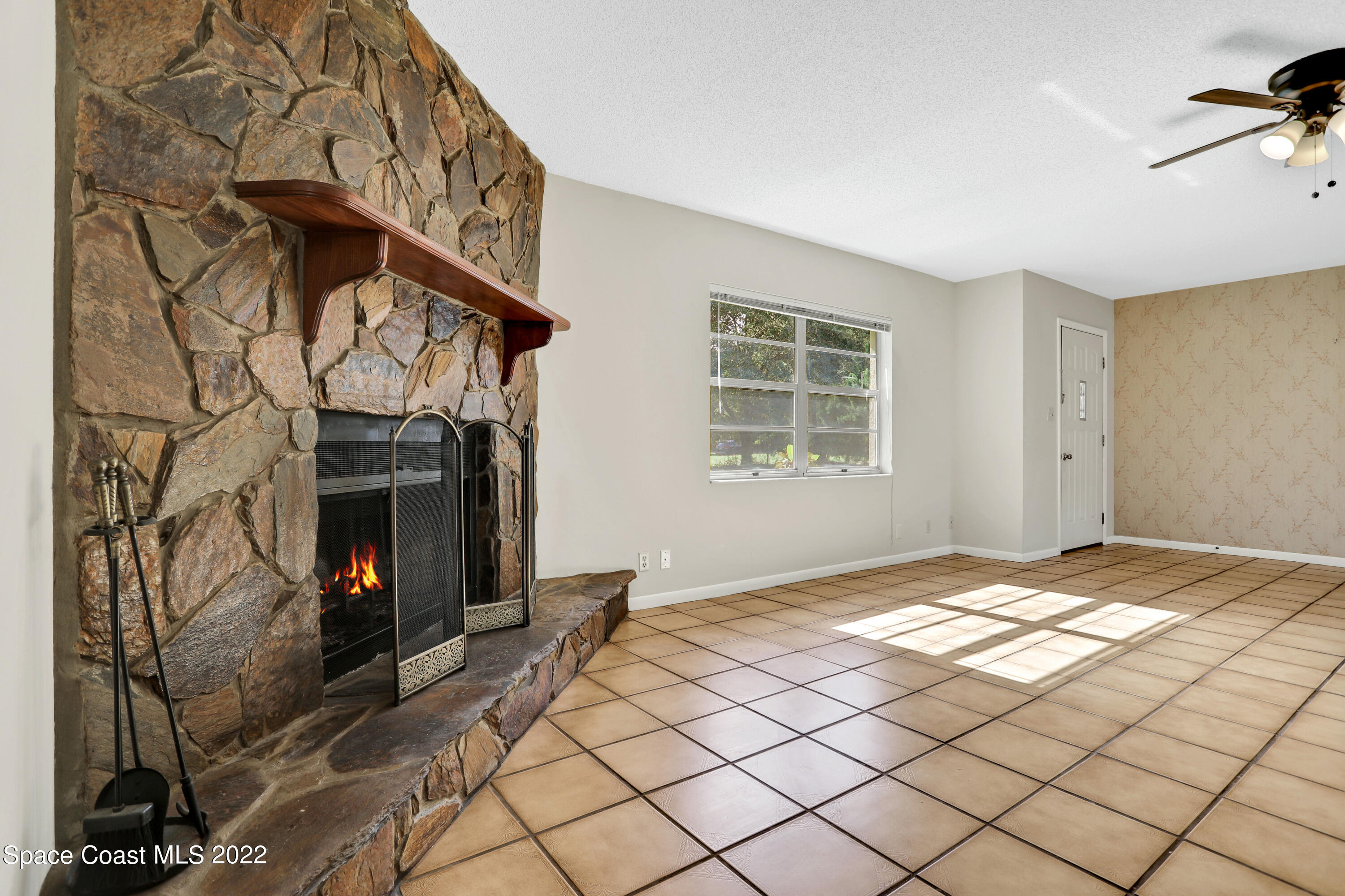 4124 April Lane Mims, FL 32754 - Photo 17 of 44 a view of a livingroom with a fireplace and window