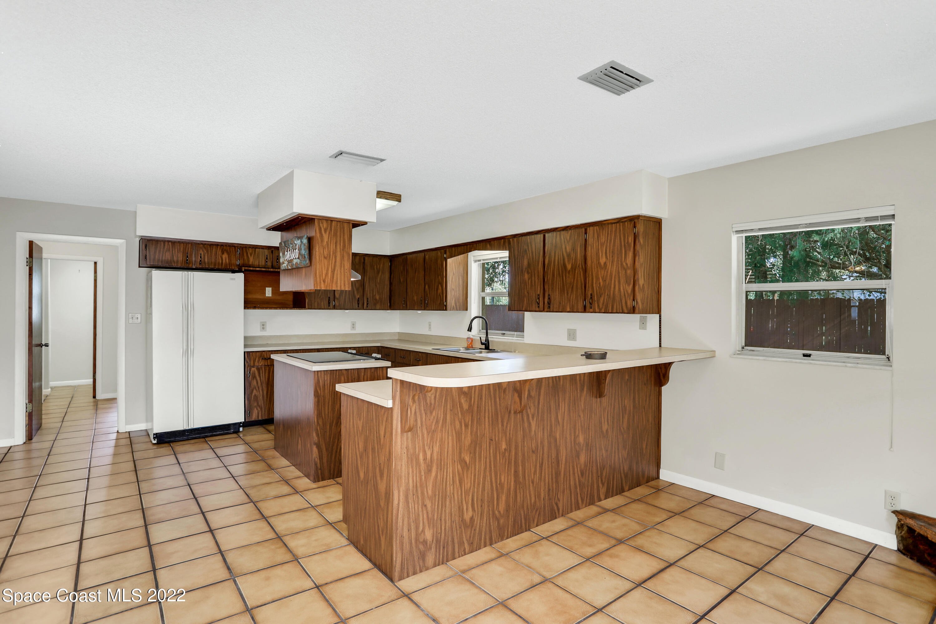 4124 April Lane Mims, FL 32754 - Photo 20 of 44 a kitchen with stainless steel appliances a sink stove and cabinets