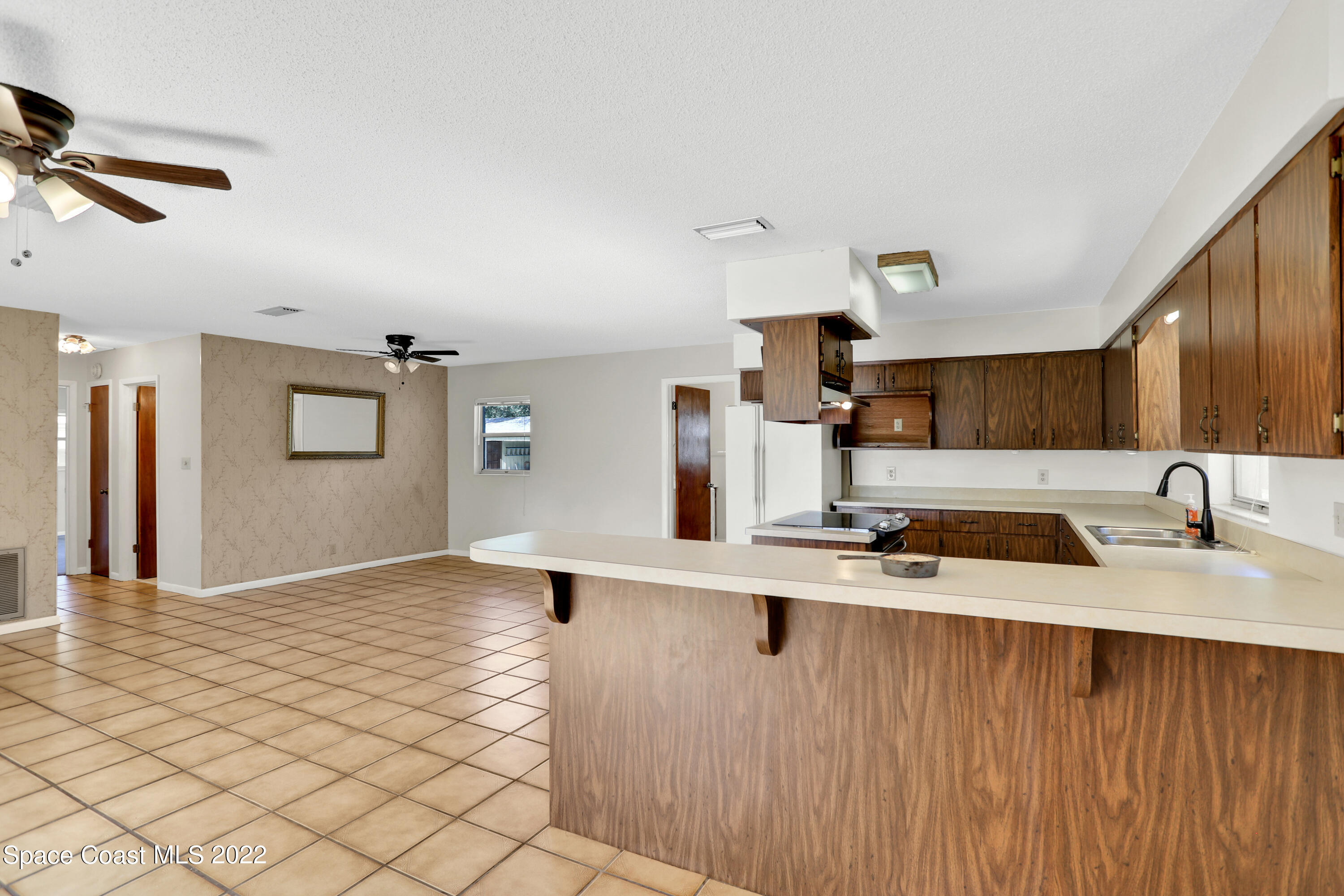 4124 April Lane Mims, FL 32754 - Photo 21 of 44 a kitchen with stainless steel appliances granite countertop a sink refrigerator and cabinets