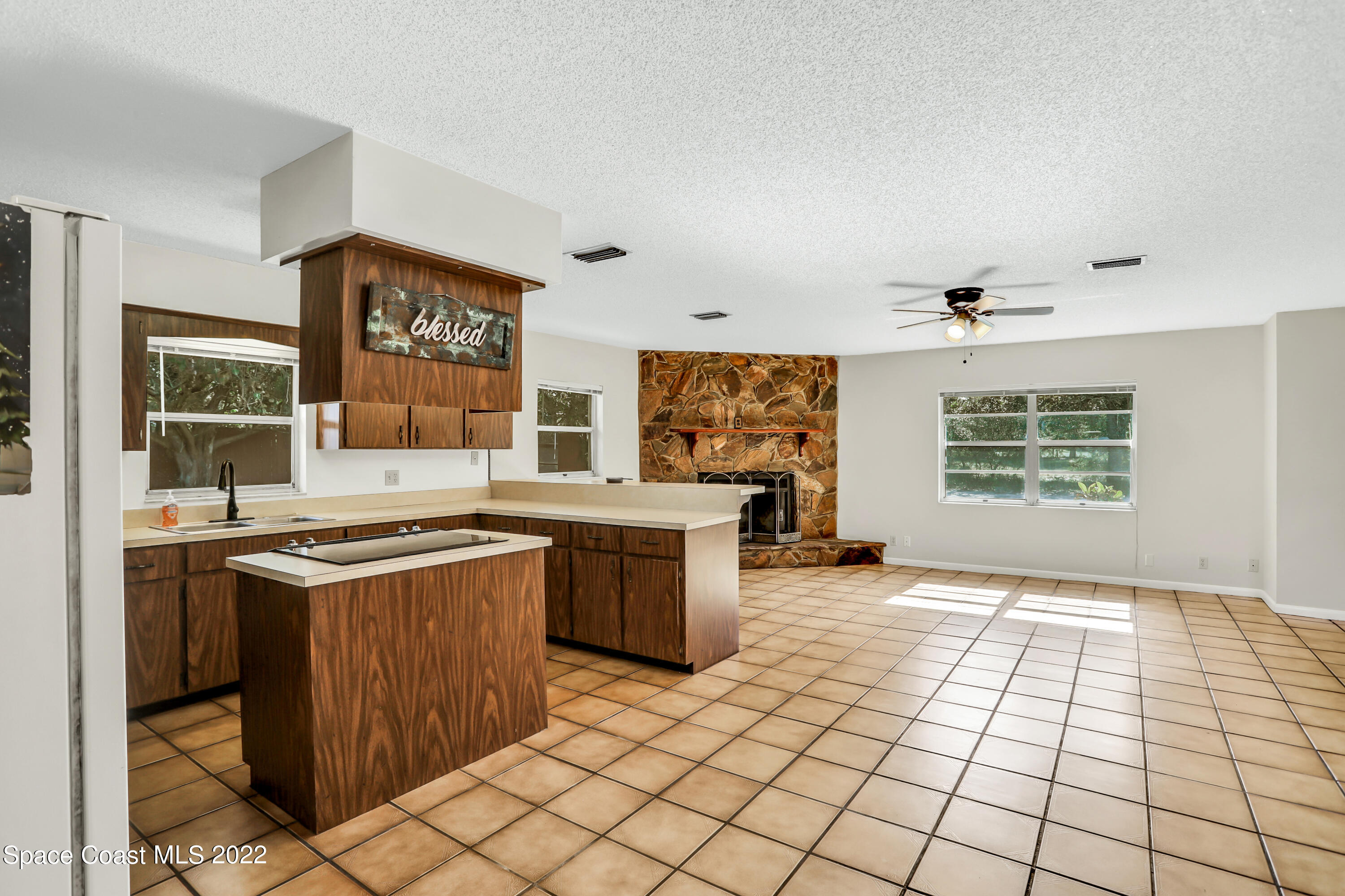4124 April Lane Mims, FL 32754 - Photo 22 of 44 a kitchen with stainless steel appliances granite countertop a stove a sink and a refrigerator
