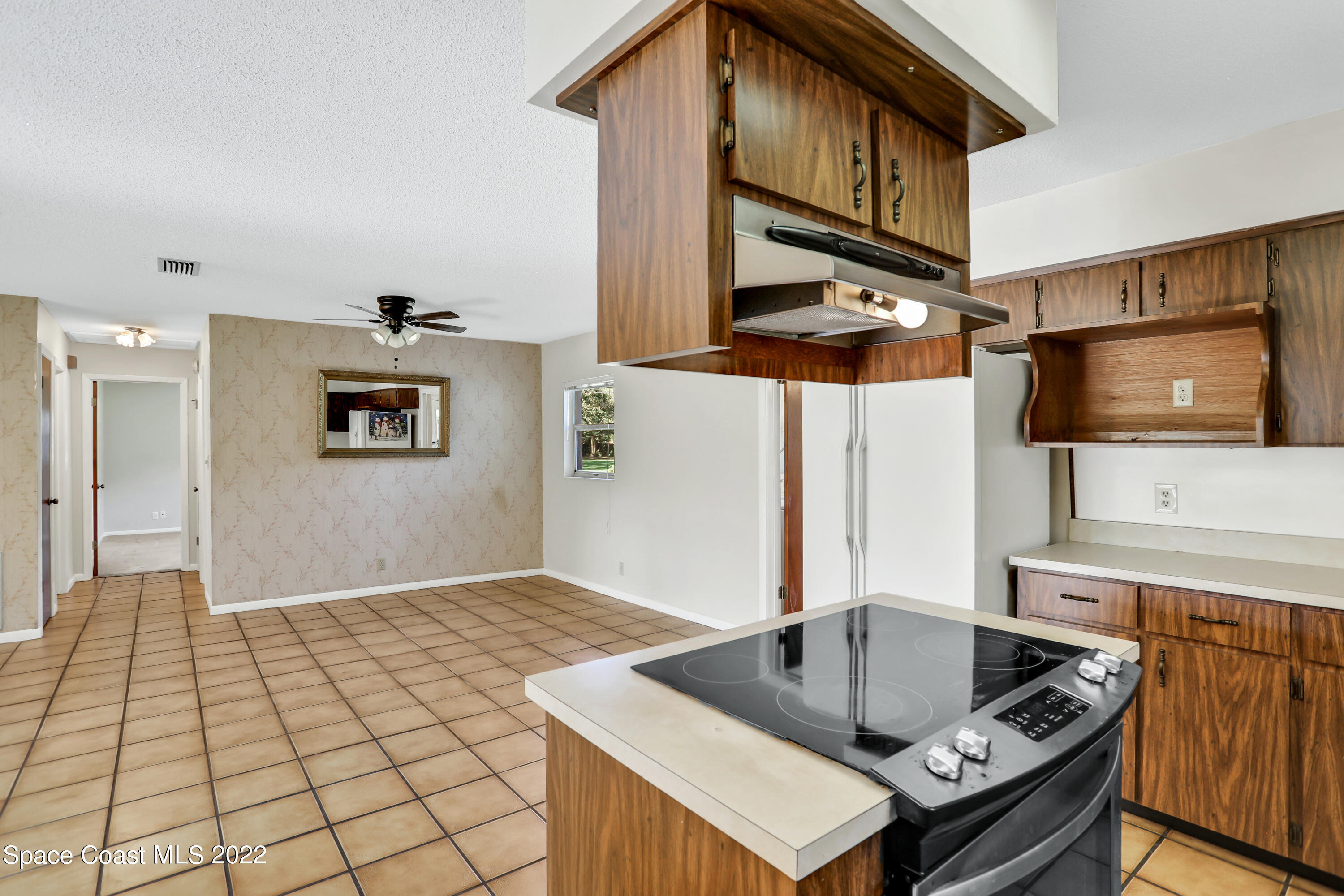 4124 April Lane Mims, FL 32754 - Photo 24 of 44 a kitchen with stainless steel appliances granite countertop a sink and a stove