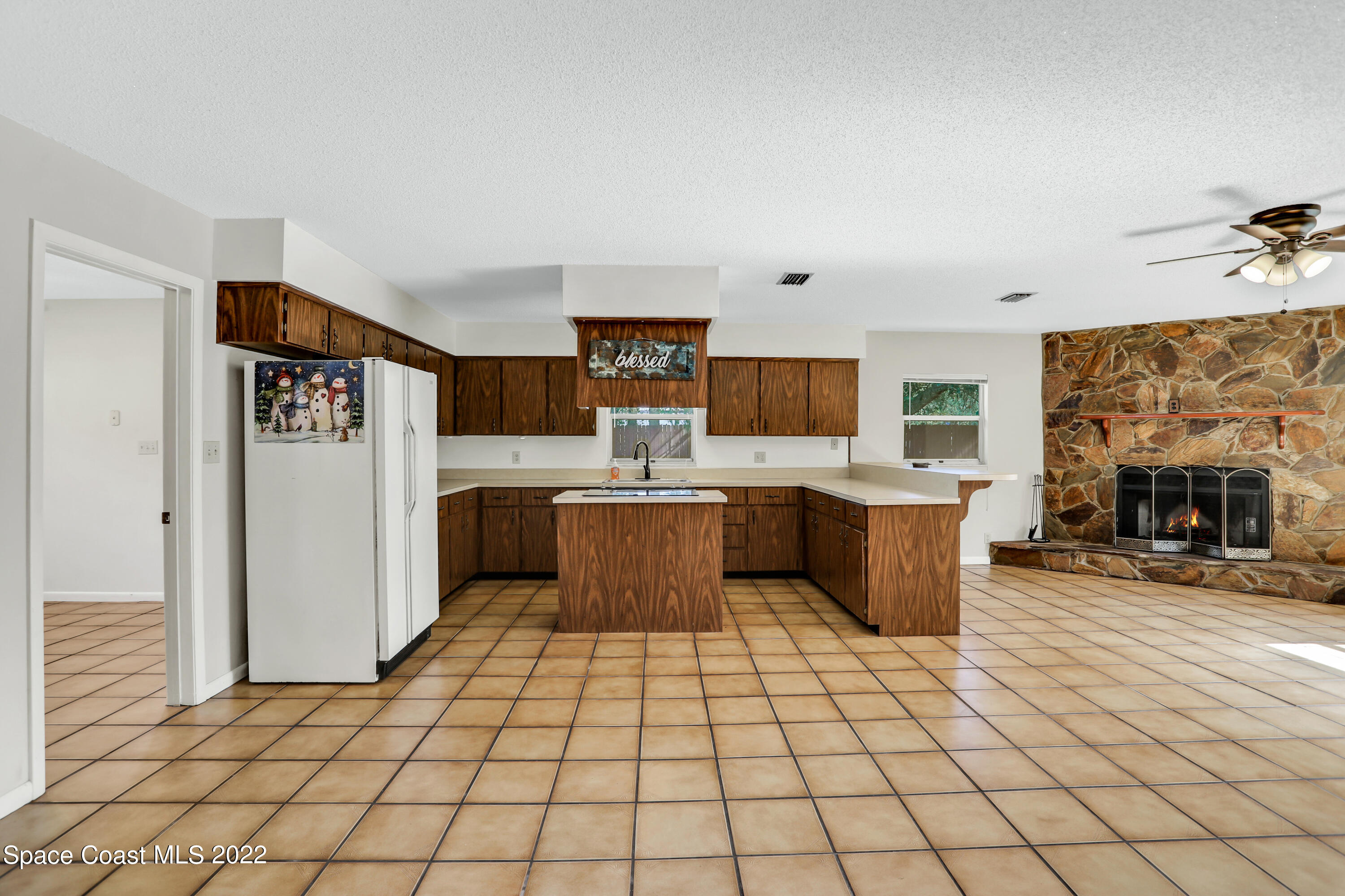 4124 April Lane Mims, FL 32754 - Photo 26 of 44 a large white kitchen with a stove a sink dishwasher and a refrigerator with wooden floor