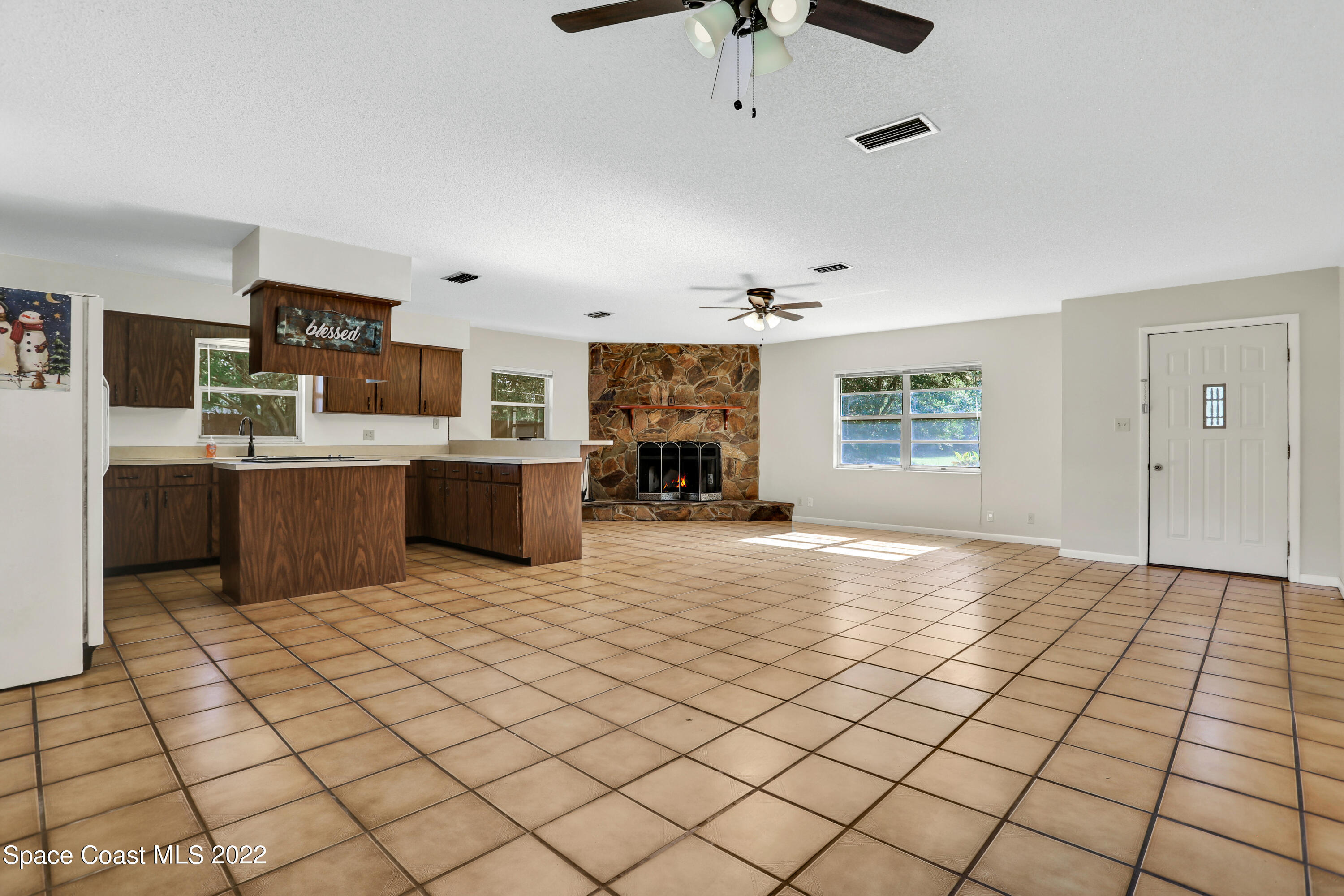 4124 April Lane Mims, FL 32754 - Photo 27 of 44 a view of a kitchen with microwave and cabinets