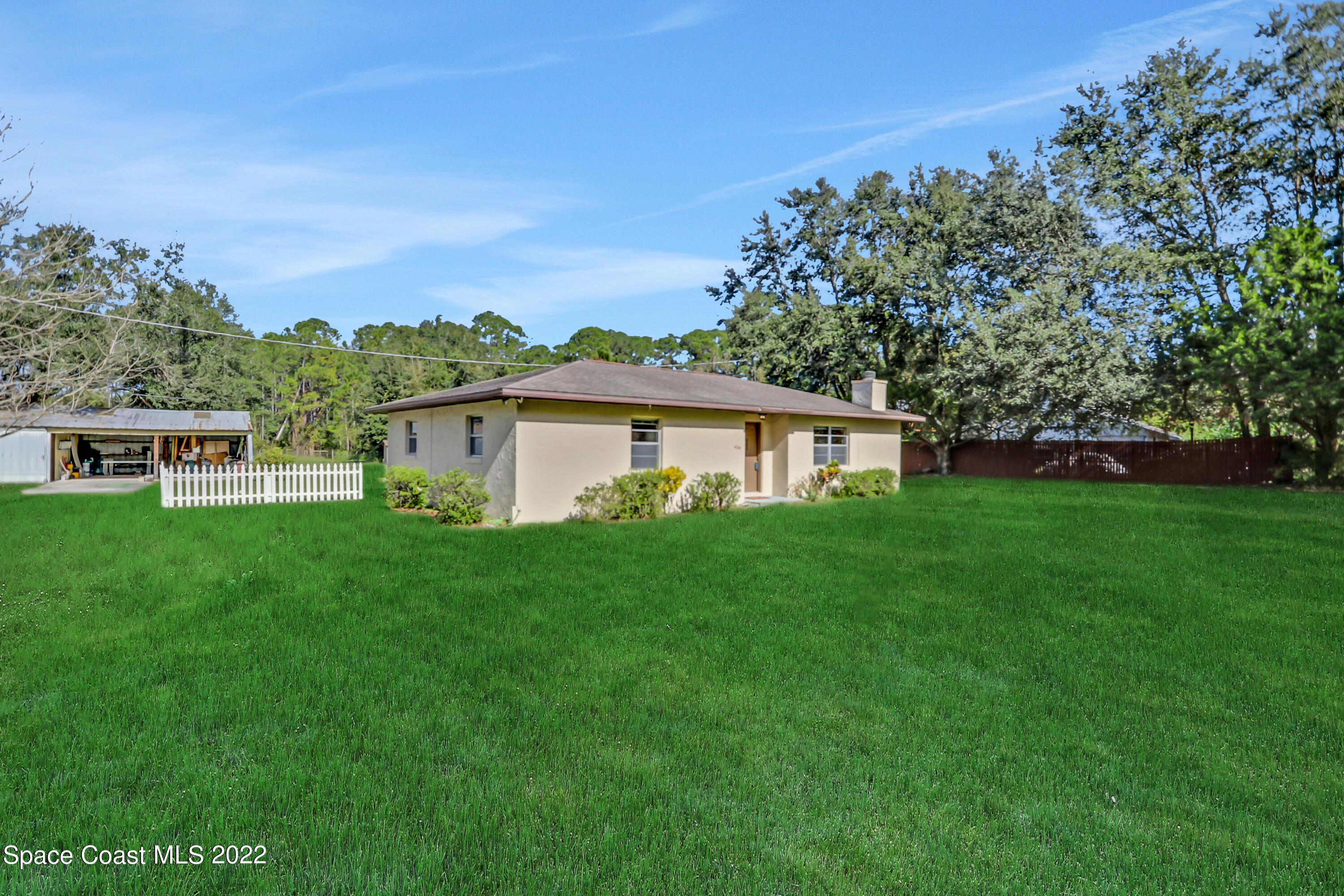 4124 April Lane Mims, FL 32754 - Photo 3 of 44 a front view of house with yard and green space