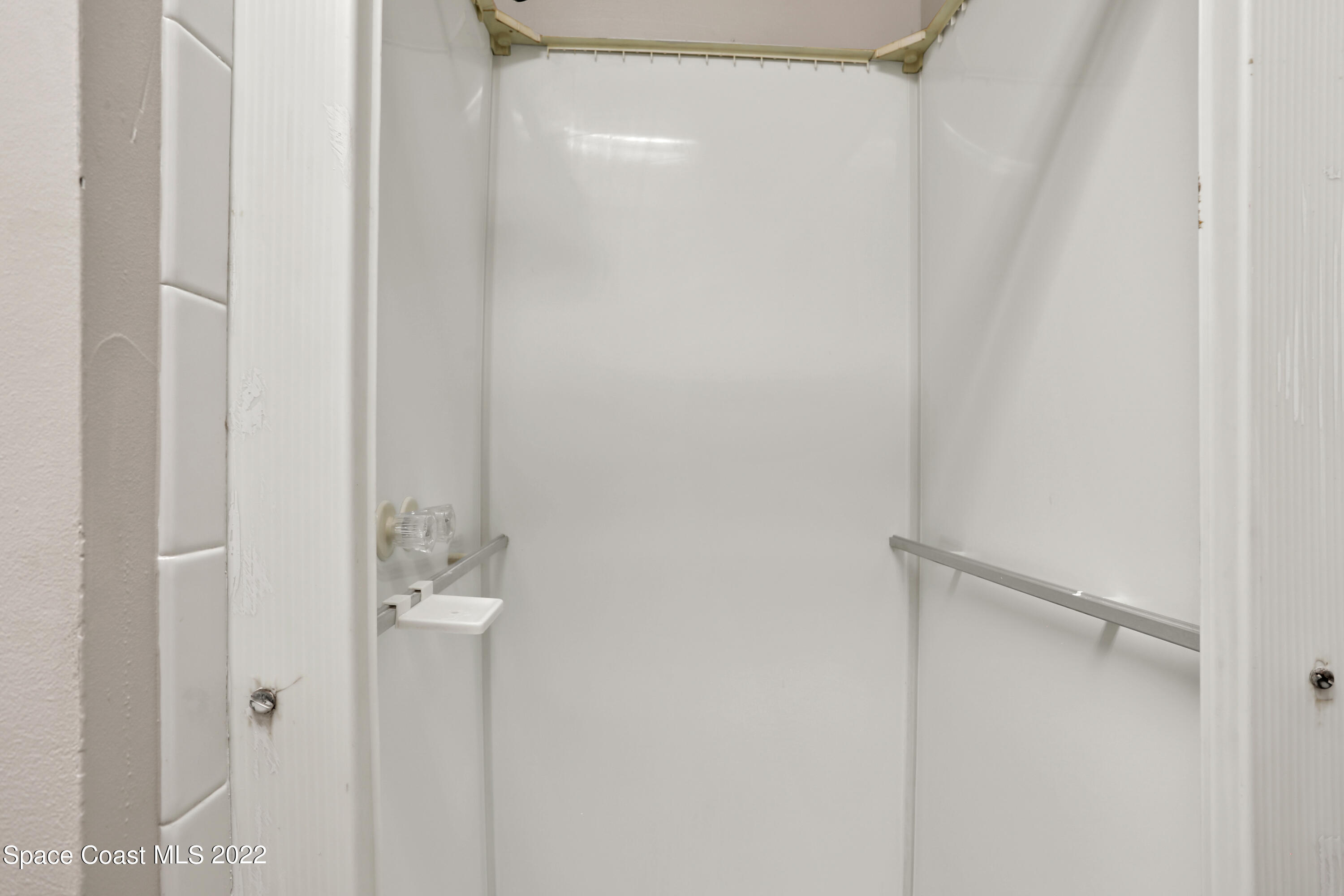 4124 April Lane Mims, FL 32754 - Photo 32 of 44 a bathroom with a glass shower door