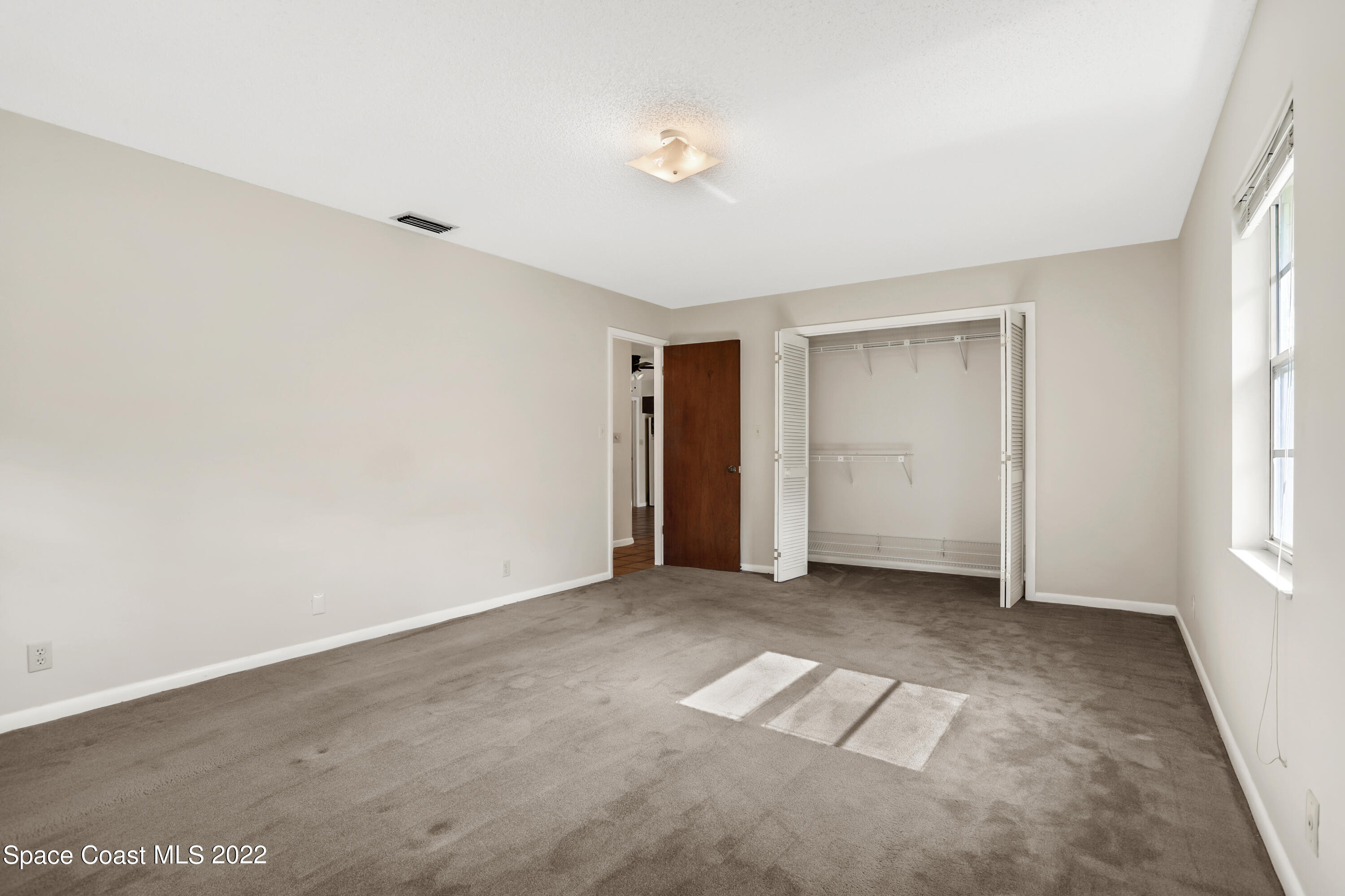 4124 April Lane Mims, FL 32754 - Photo 35 of 44 an empty room with windows