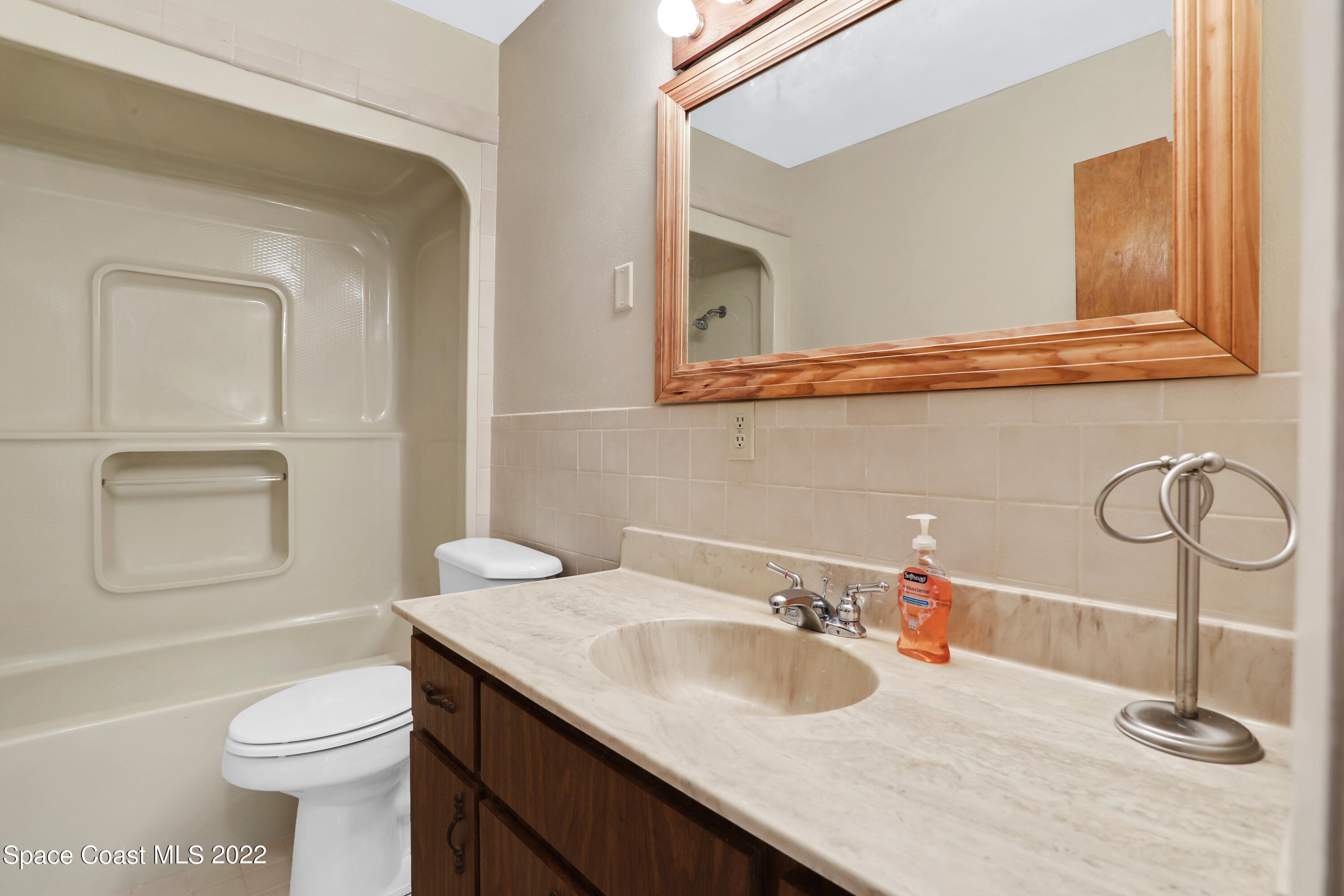4124 April Lane Mims, FL 32754 - Photo 37 of 44 a bathroom with a sink a toilet and mirror