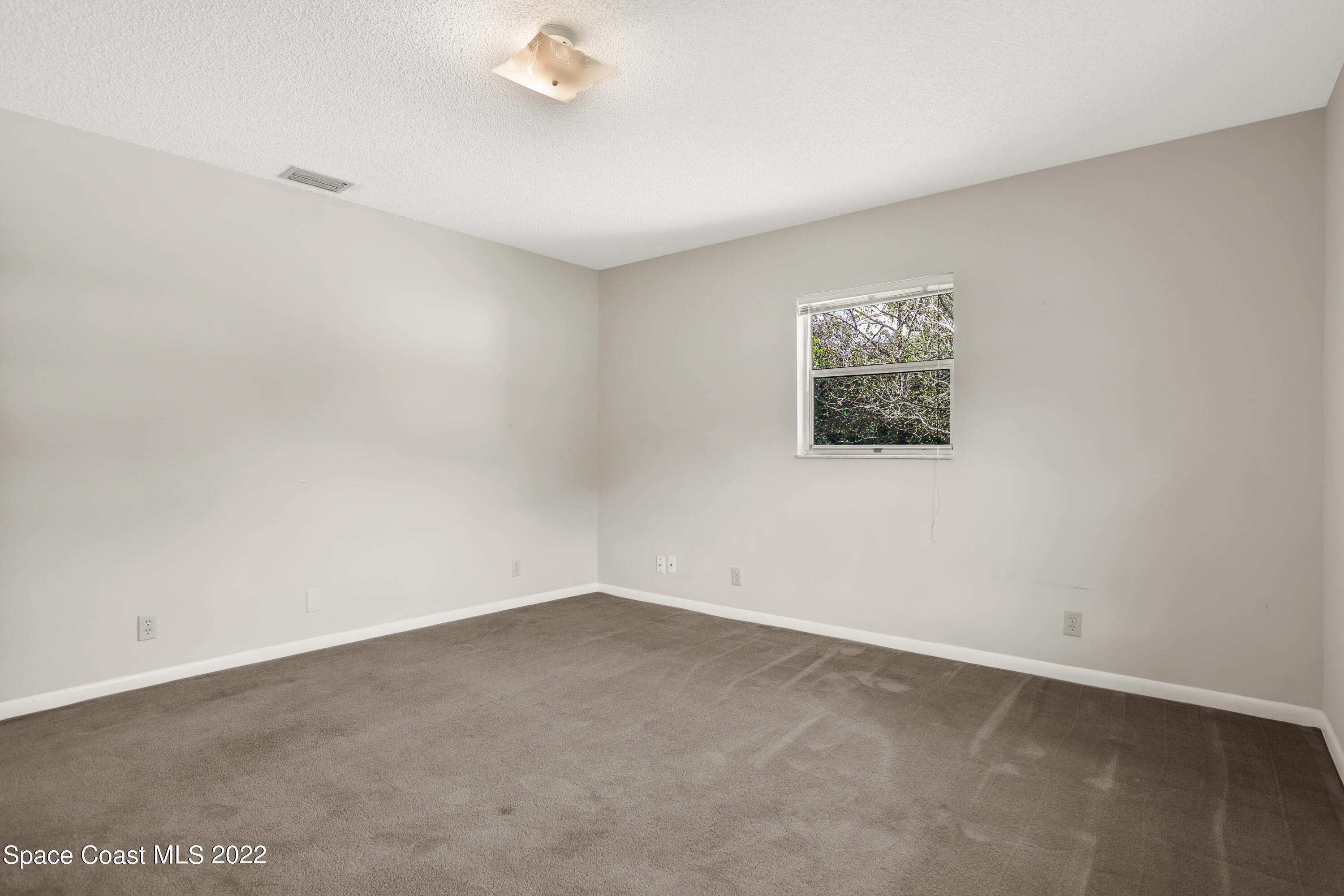 4124 April Lane Mims, FL 32754 - Photo 38 of 44 an empty room with a empty space and window
