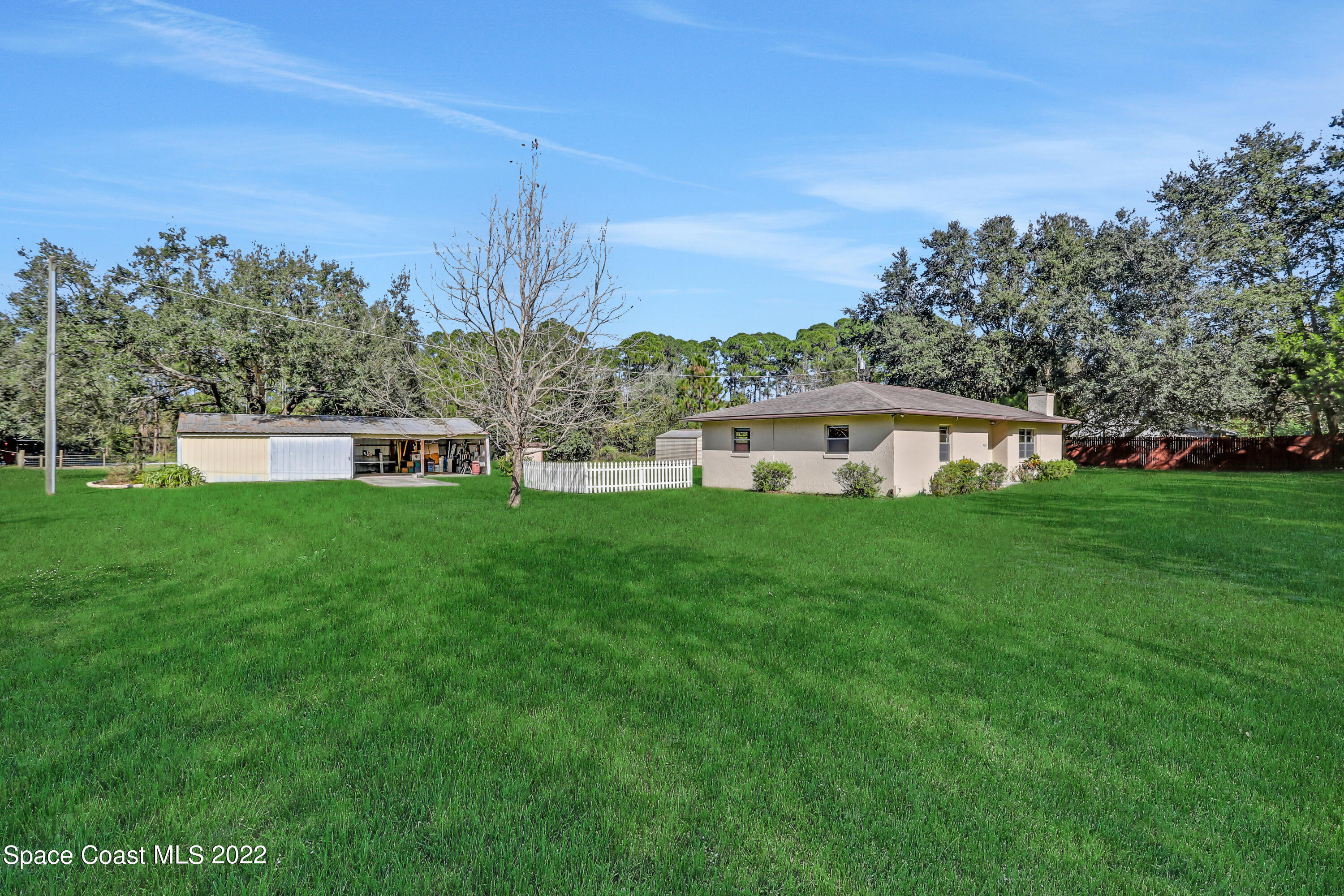 4124 April Lane Mims, FL 32754 - Photo 4 of 44 a view of a house with a yard from a garden