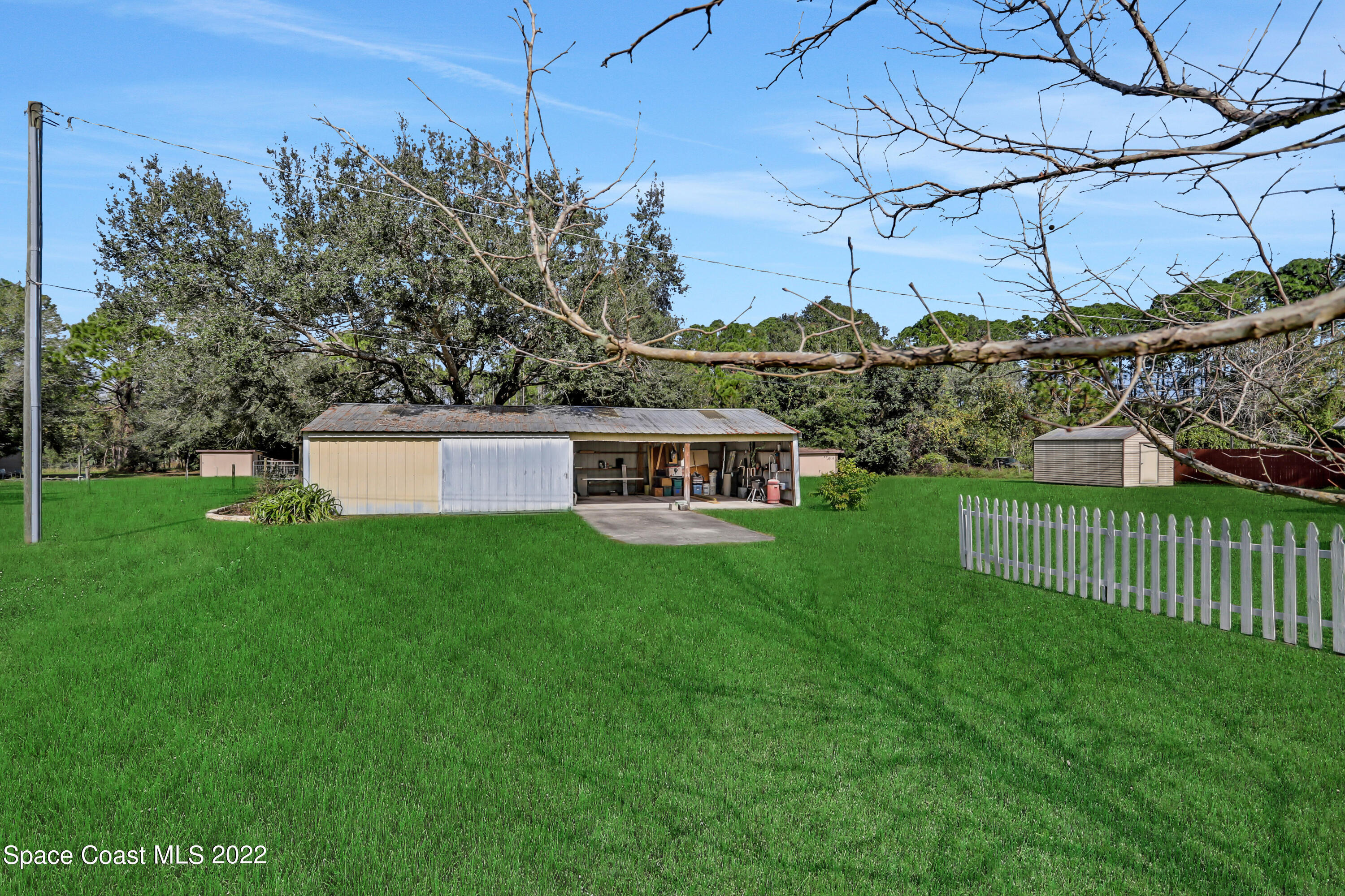 4124 April Lane Mims, FL 32754 - Photo 5 of 44 a front view of a house with a garden
