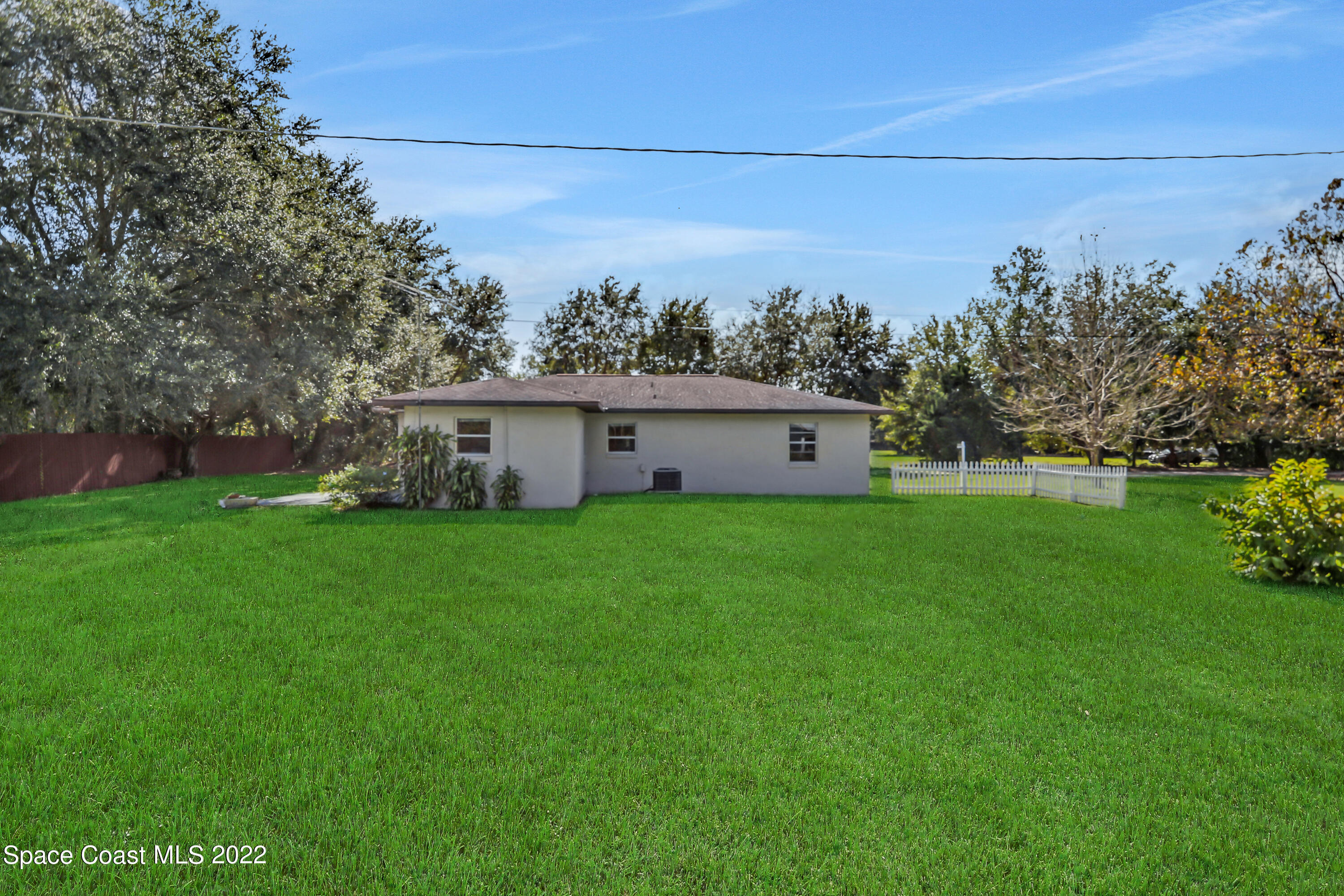 4124 April Lane Mims, FL 32754 - Photo 7 of 44 a view of a house with backyard and garden