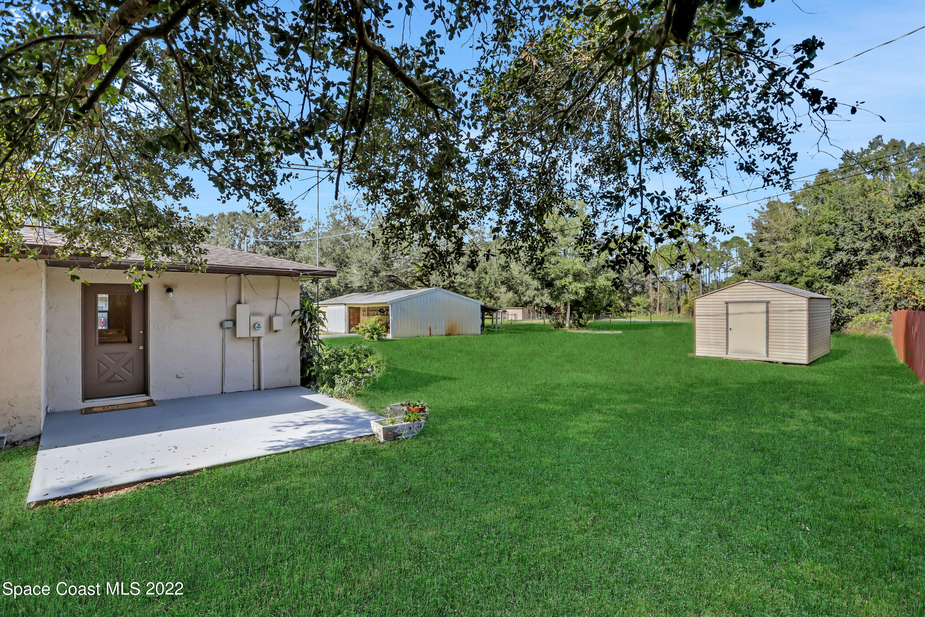 4124 April Lane Mims, FL 32754 - Photo 9 of 44 a front view of a house with a yard and a garage