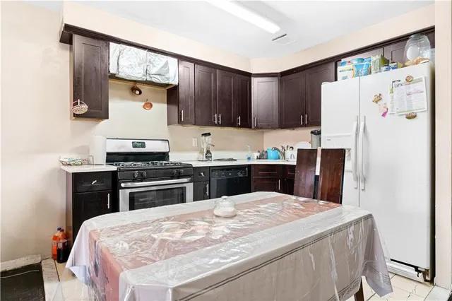 a kitchen with a stove a refrigerator and a sink