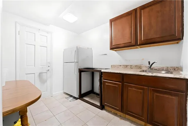 a kitchen with stainless steel appliances granite countertop a sink and a refrigerator