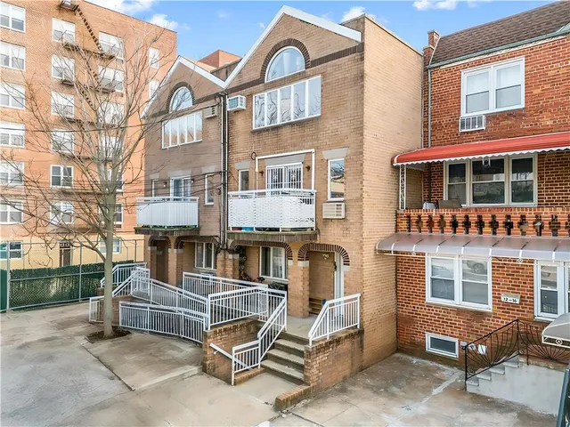 a view of a brick building with many windows