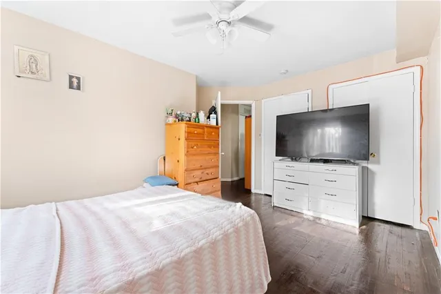 a bedroom with a flat screen television and a bed