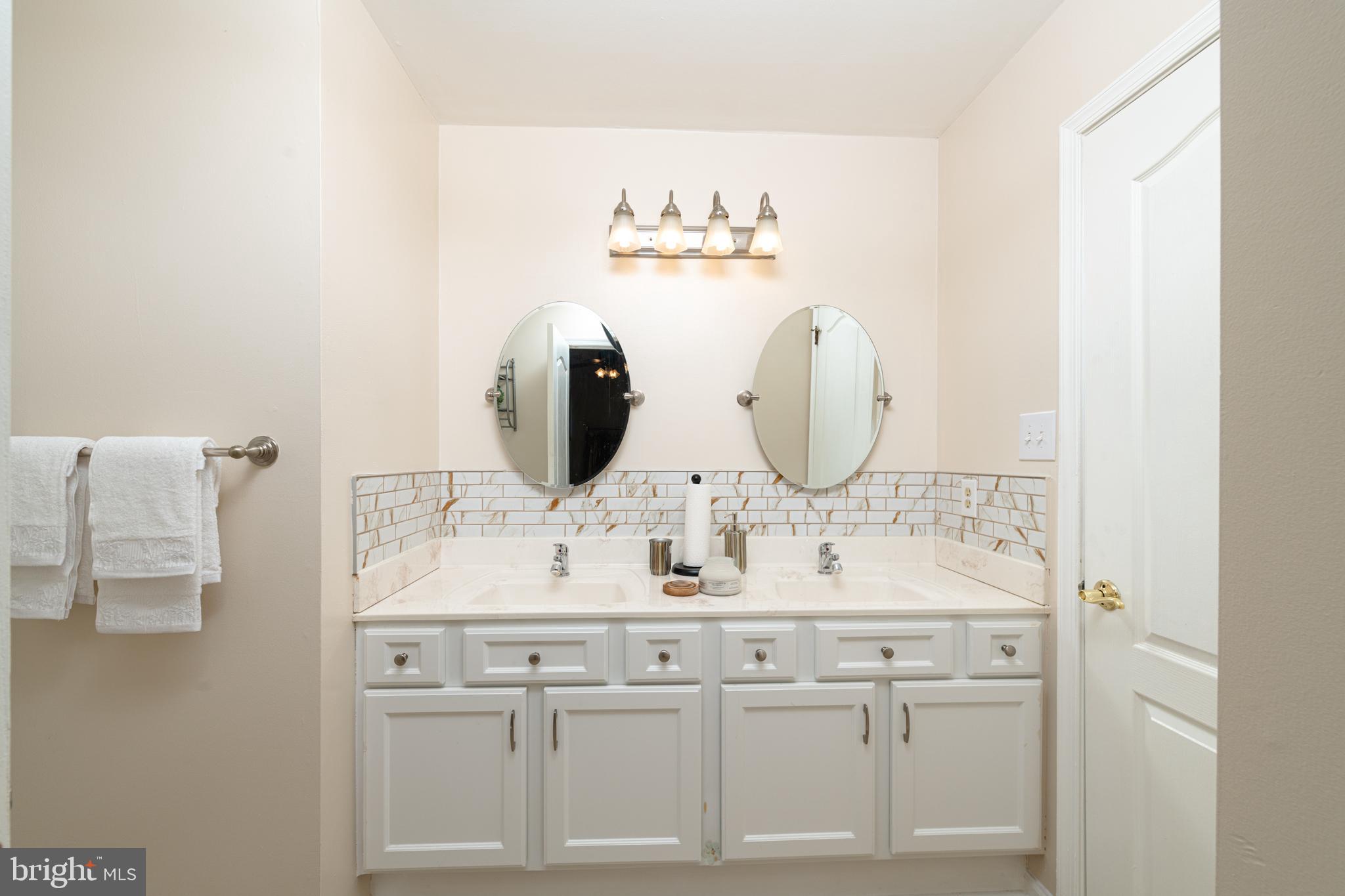 72 Rosalind Circle Sicklerville, NJ 08081 - Photo 27 of 47 a bathroom with a sink vanity and mirror