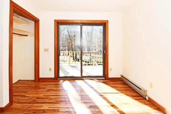 a view of a room with wooden floor and windows