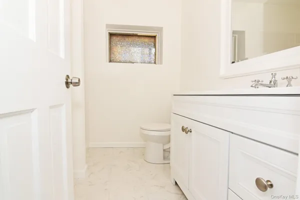 a bathroom with a toilet and a sink