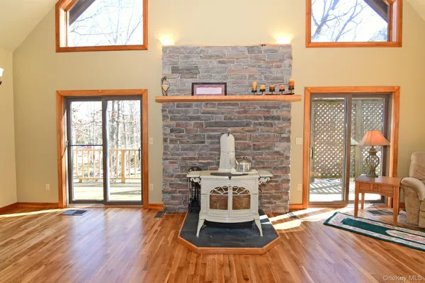 a living room with furniture a fireplace and wooden floor
